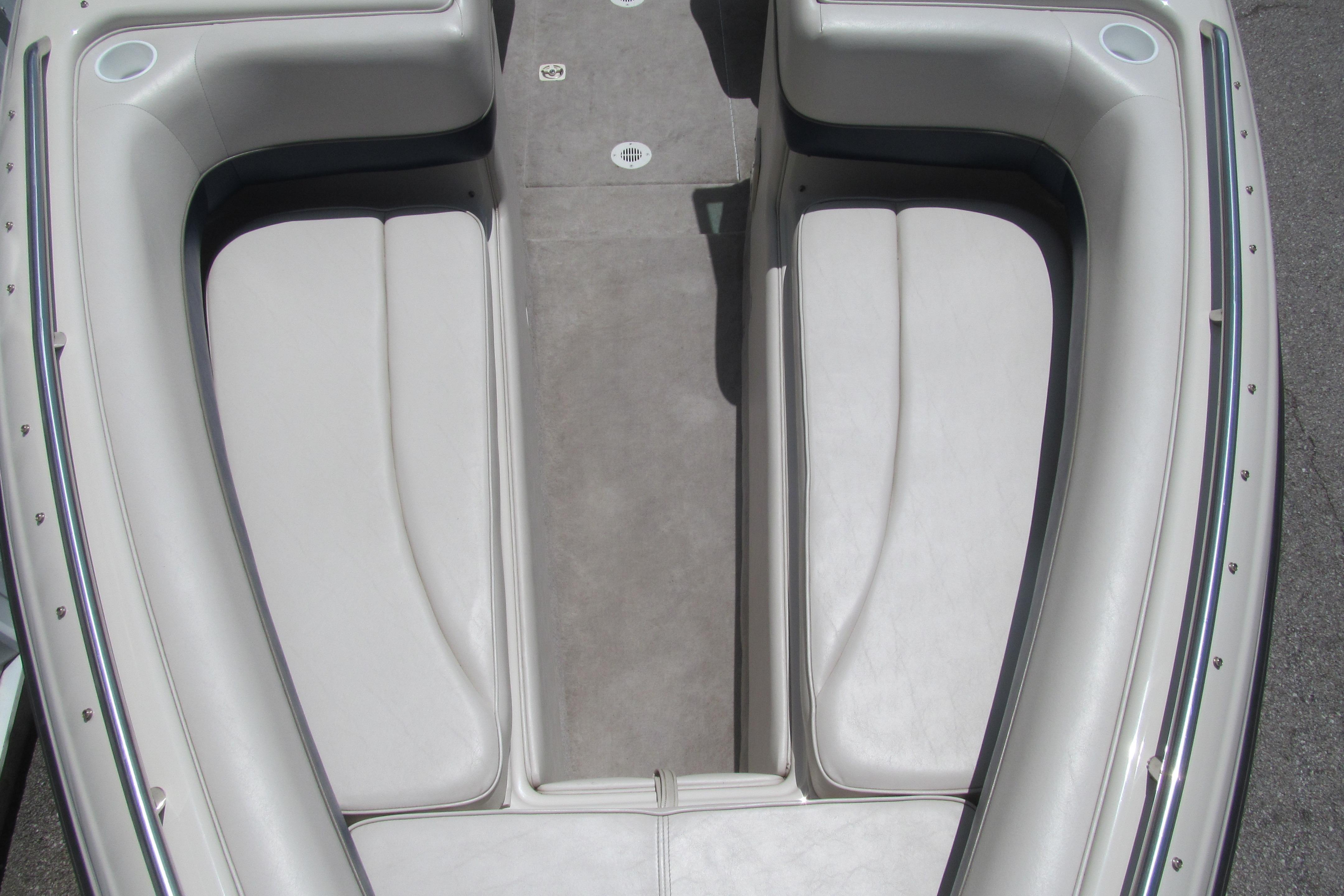 2001 Crownline 225 BR boat interior with gray seating and carpeted floor.