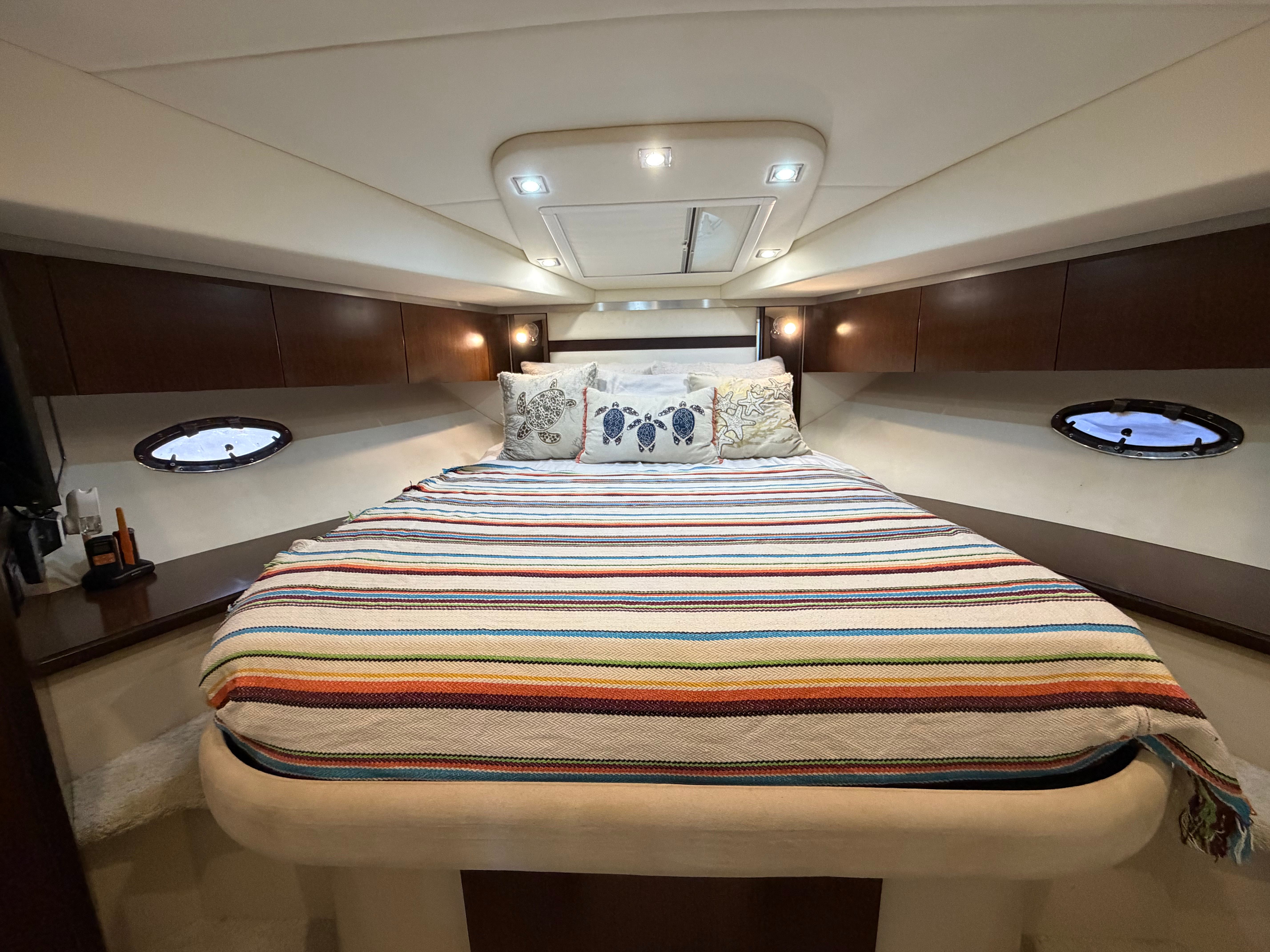 Interior of 2012 Cruisers Yachts 430 Sports Coupe with cozy bedroom.