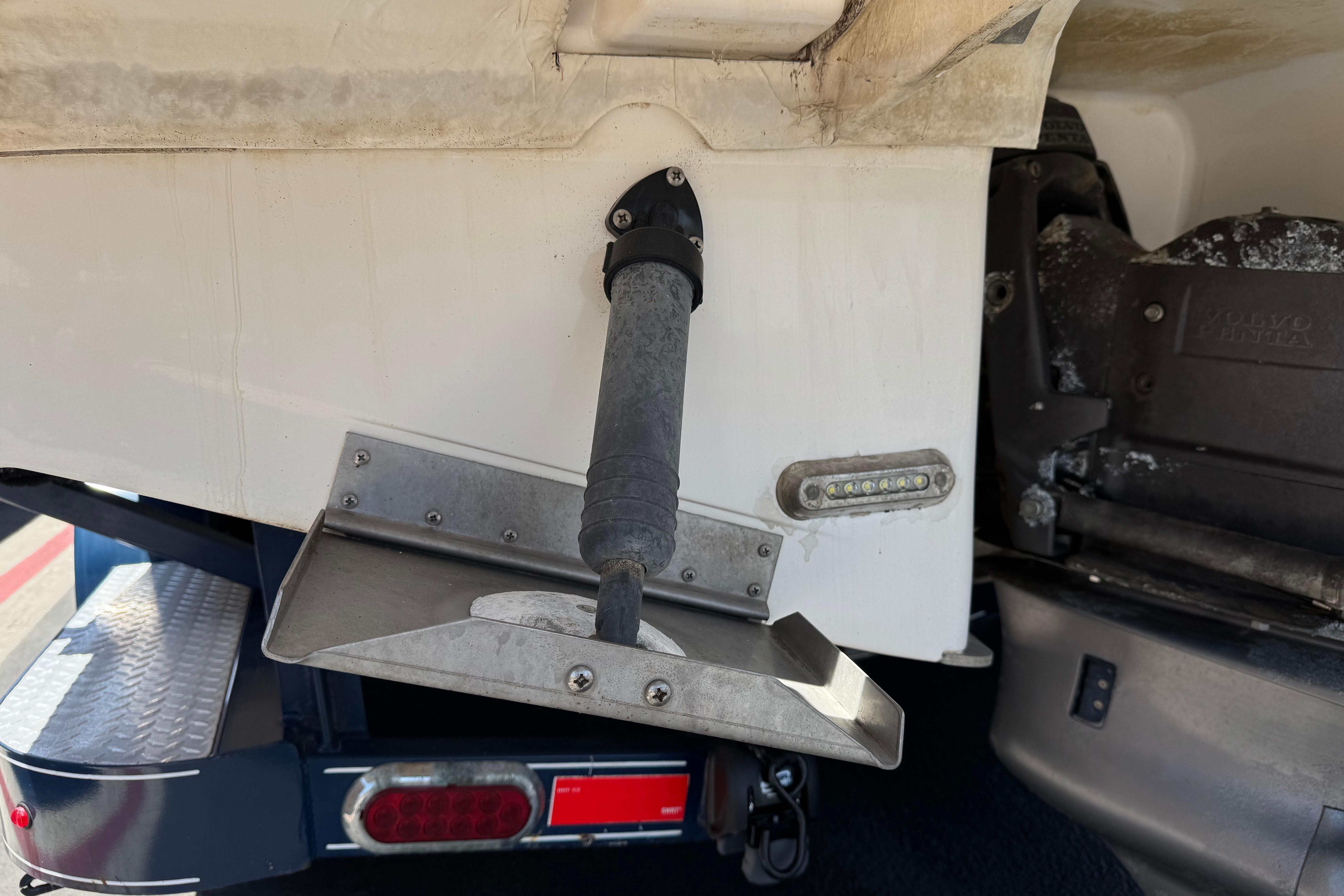 Close-up of a 2013 Regal 28 Express boat's trim tab and hydraulic system.