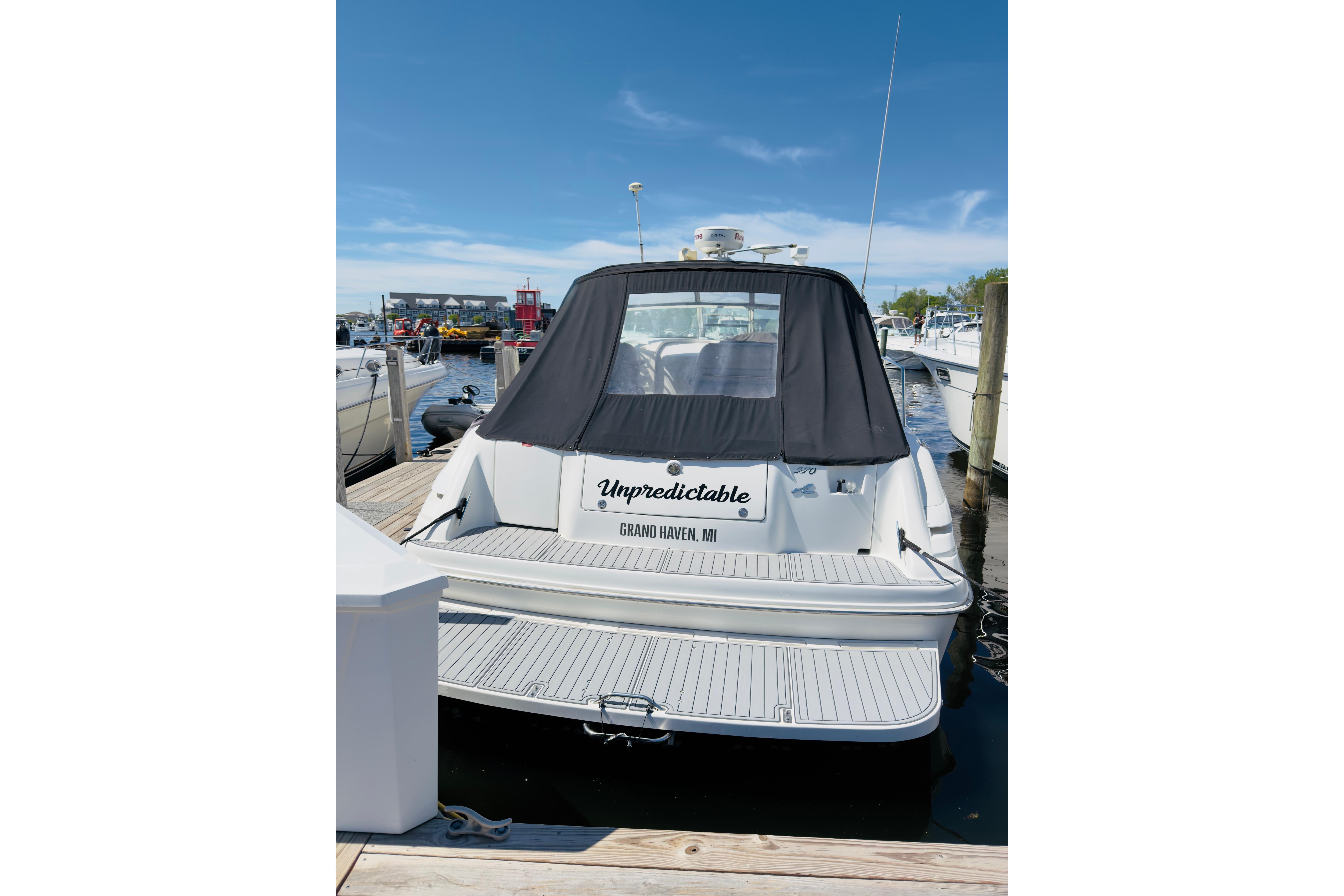 1995 Sea Ray Sundancer 370 docked, rear view with black cover, Grand Haven, MI.