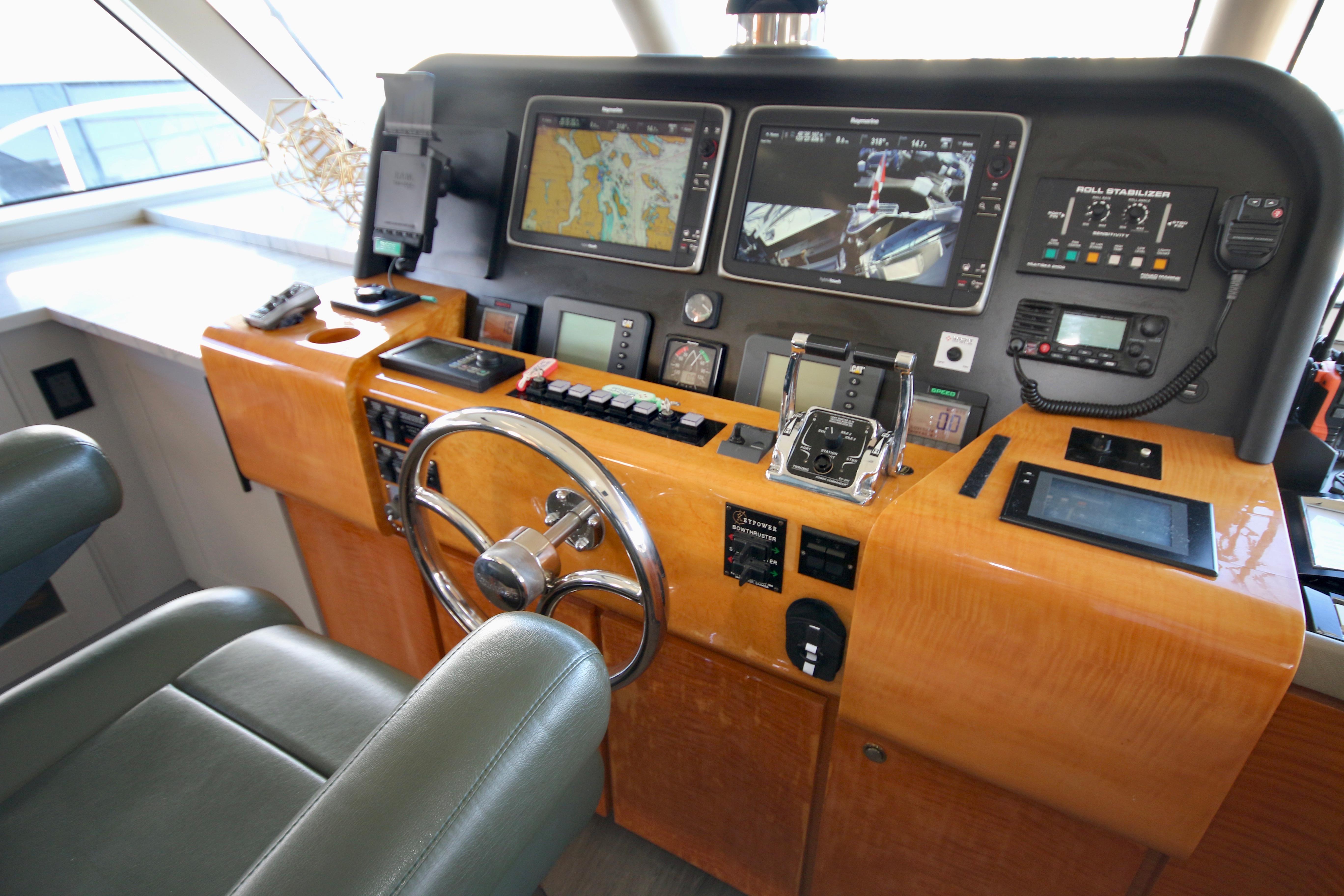 Pilothouse of 2002 Cheoy Lee 66, featuring navigation screens and controls.