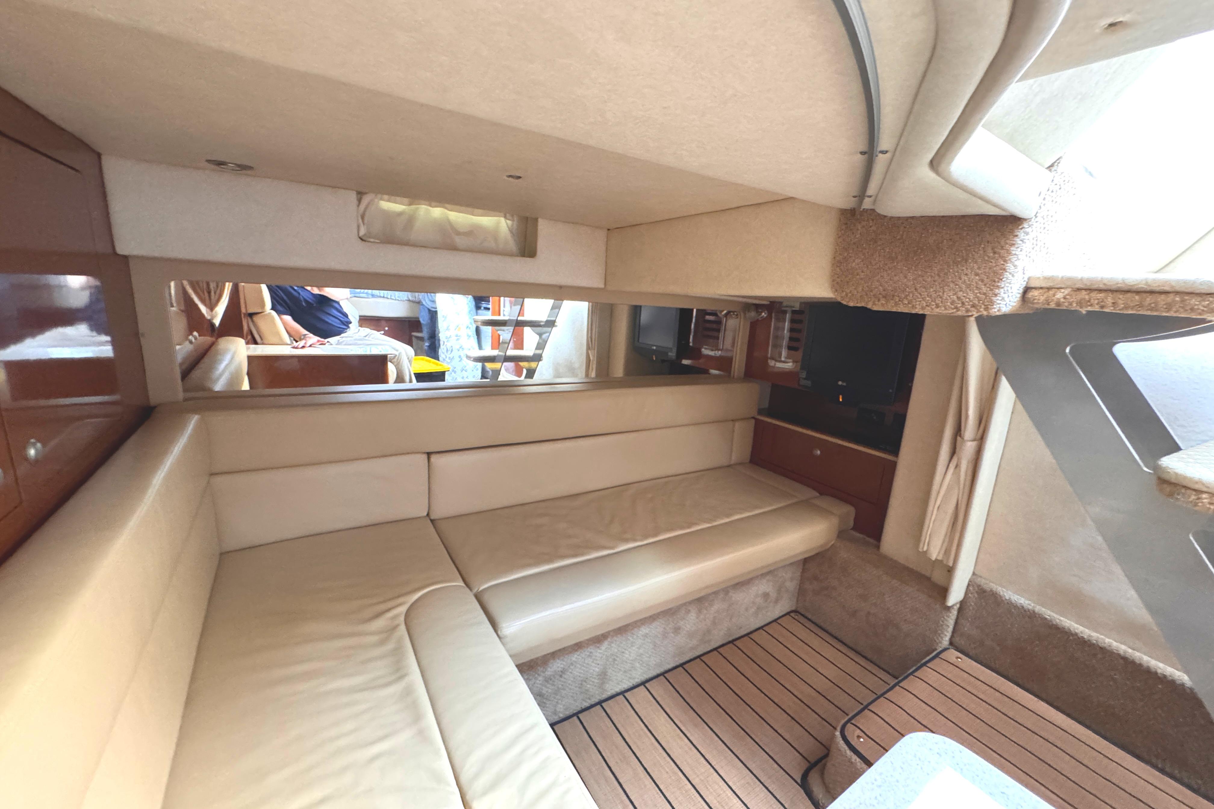 Interior of 2008 Sea Ray Sundancer 350 yacht with beige seating and wooden flooring.