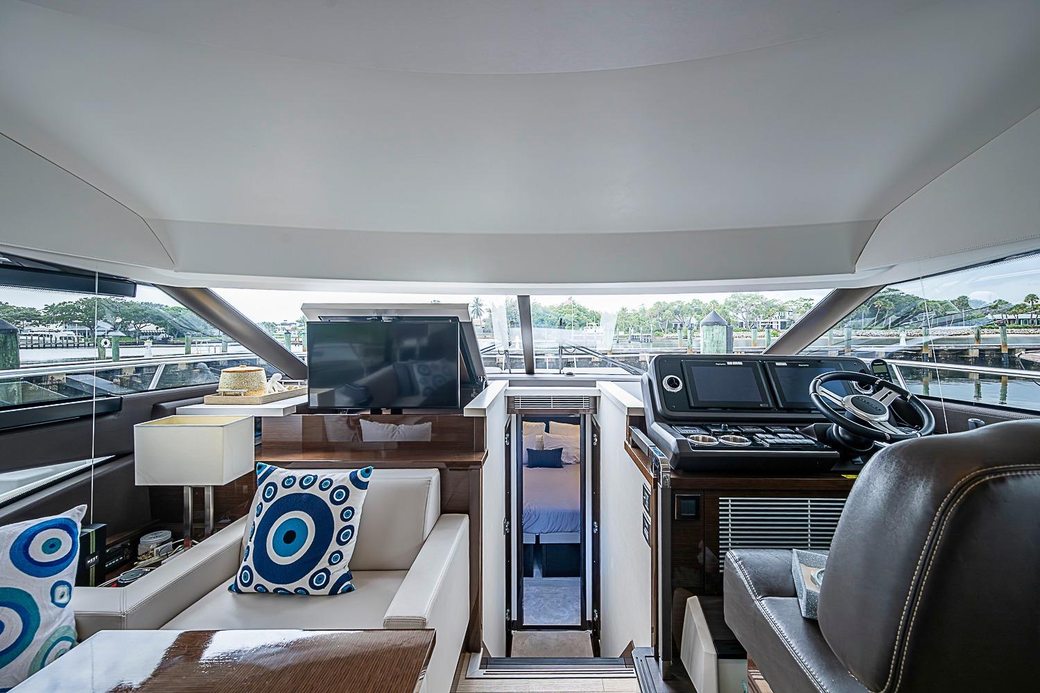 Luxurious interior of 2021 Prestige 520 yacht with modern helm and stylish seating.