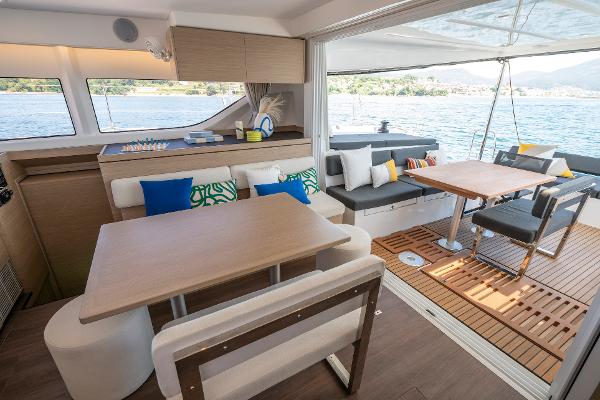 Luxurious interior of 2025 Lagoon 43 yacht with modern seating and scenic water view.