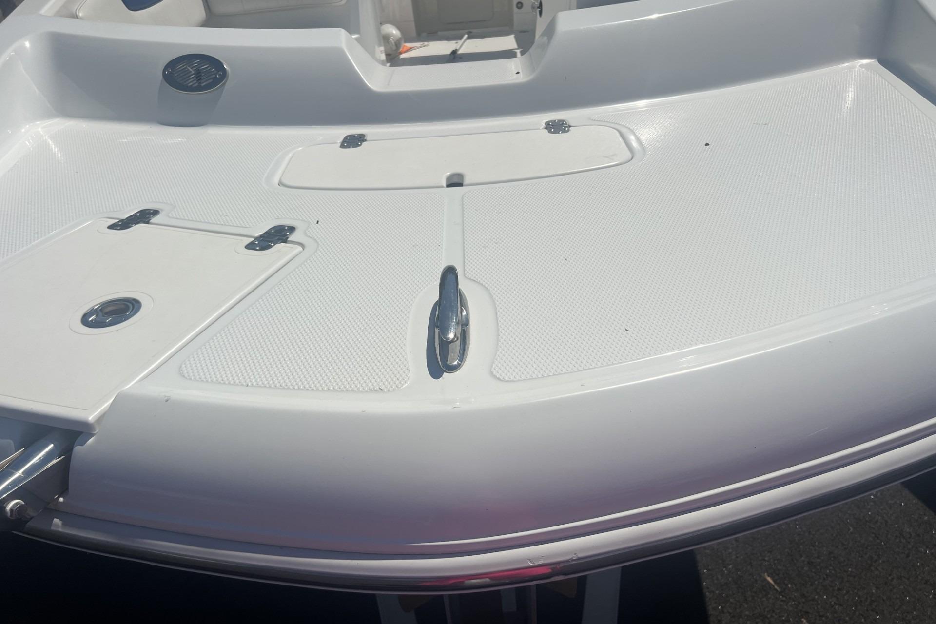 2017 Tahoe 2150 boat deck with storage compartments and cleat.