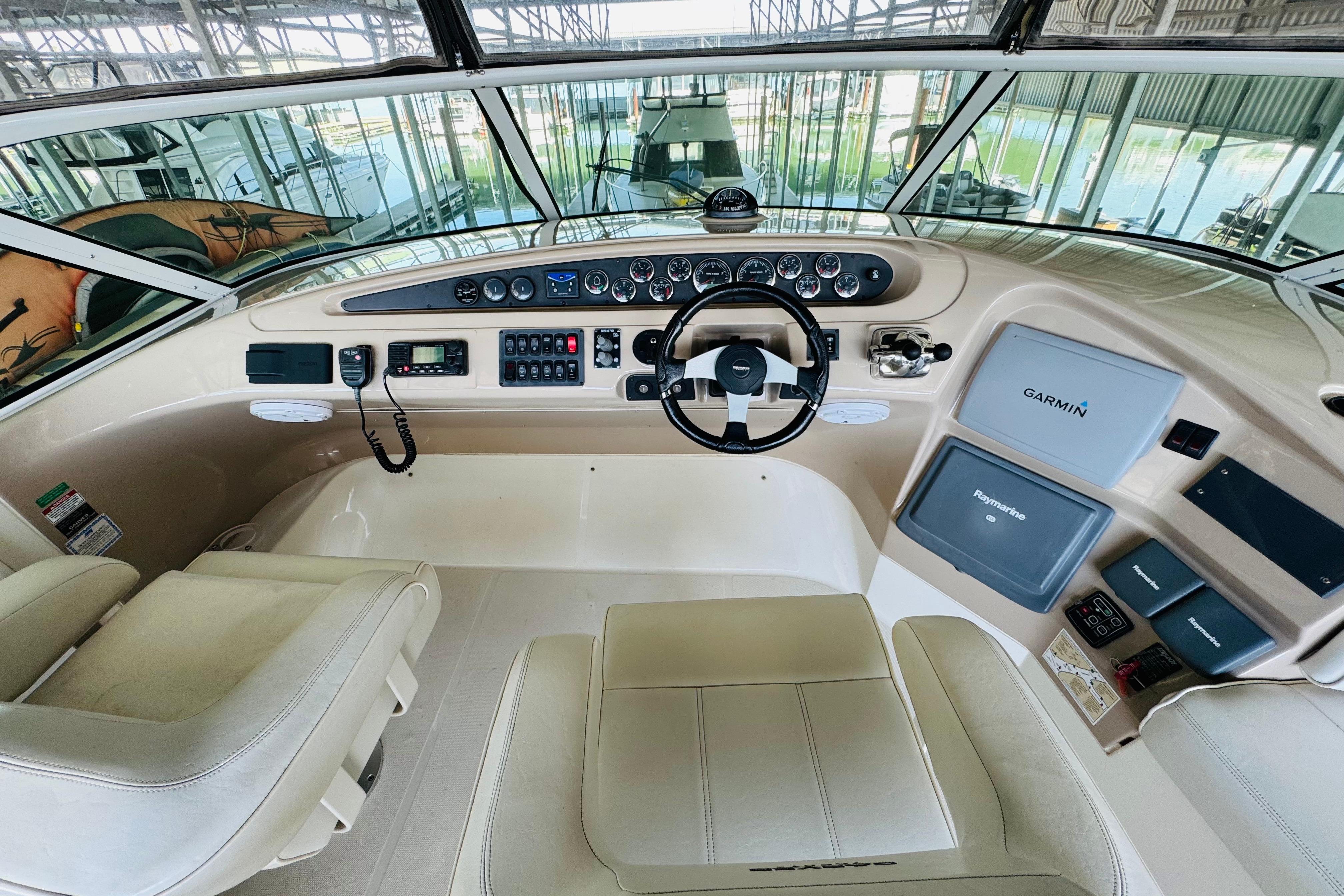 Interior helm of 2006 Carver 46 Voyager yacht with modern navigation equipment.