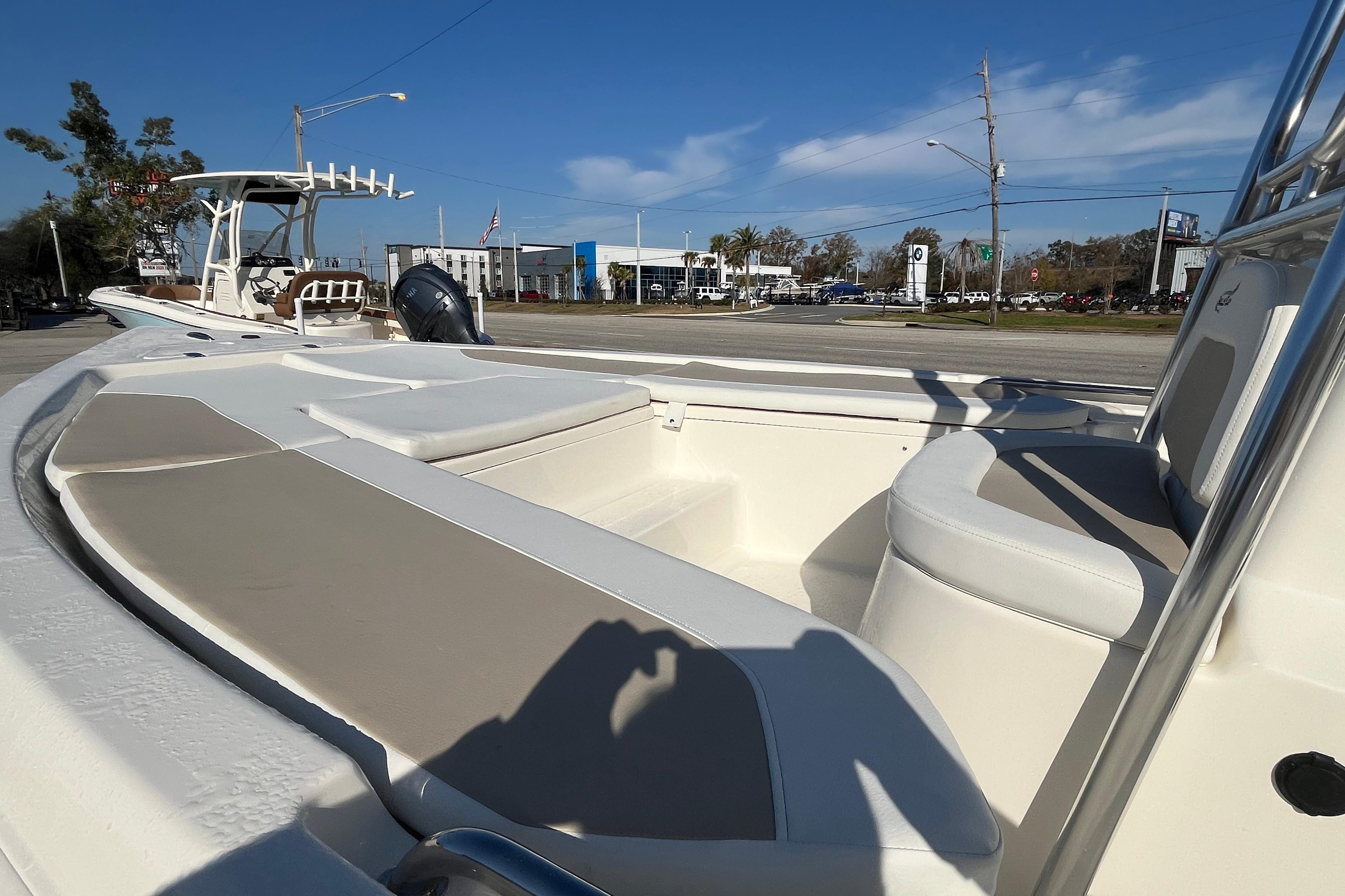 2026 Bulls Bay 2200 boat interior with seating, parked outdoors under clear blue sky.