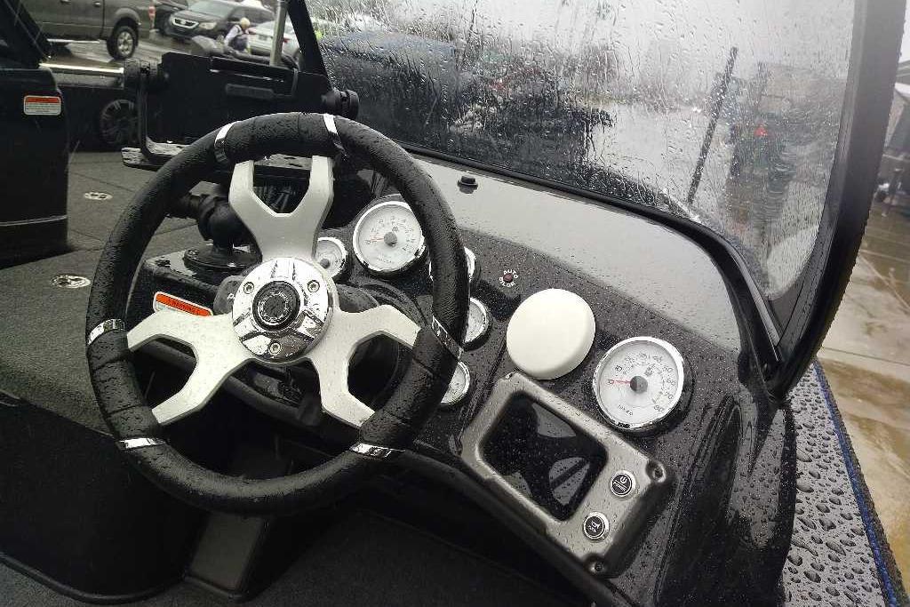 Steering wheel and dashboard of 2026 Nitro ZV19 Sport Pro boat in rainy weather.