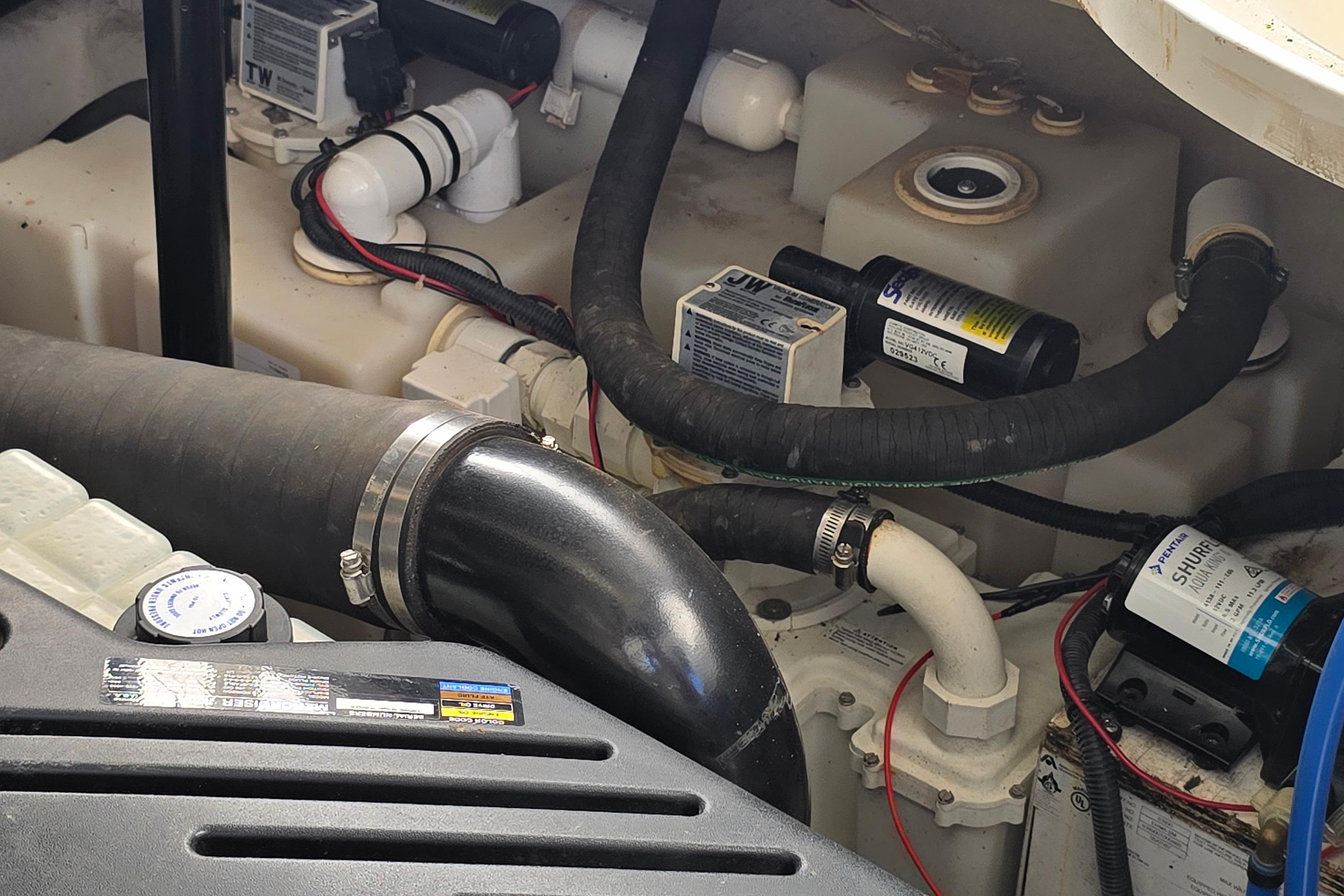 Engine compartment of a 2007 Sea Ray 340 Sundancer with hoses and components visible.
