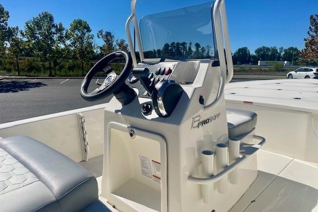 2026 Mako 18 Pro Skiff boat interior with steering console and seating.