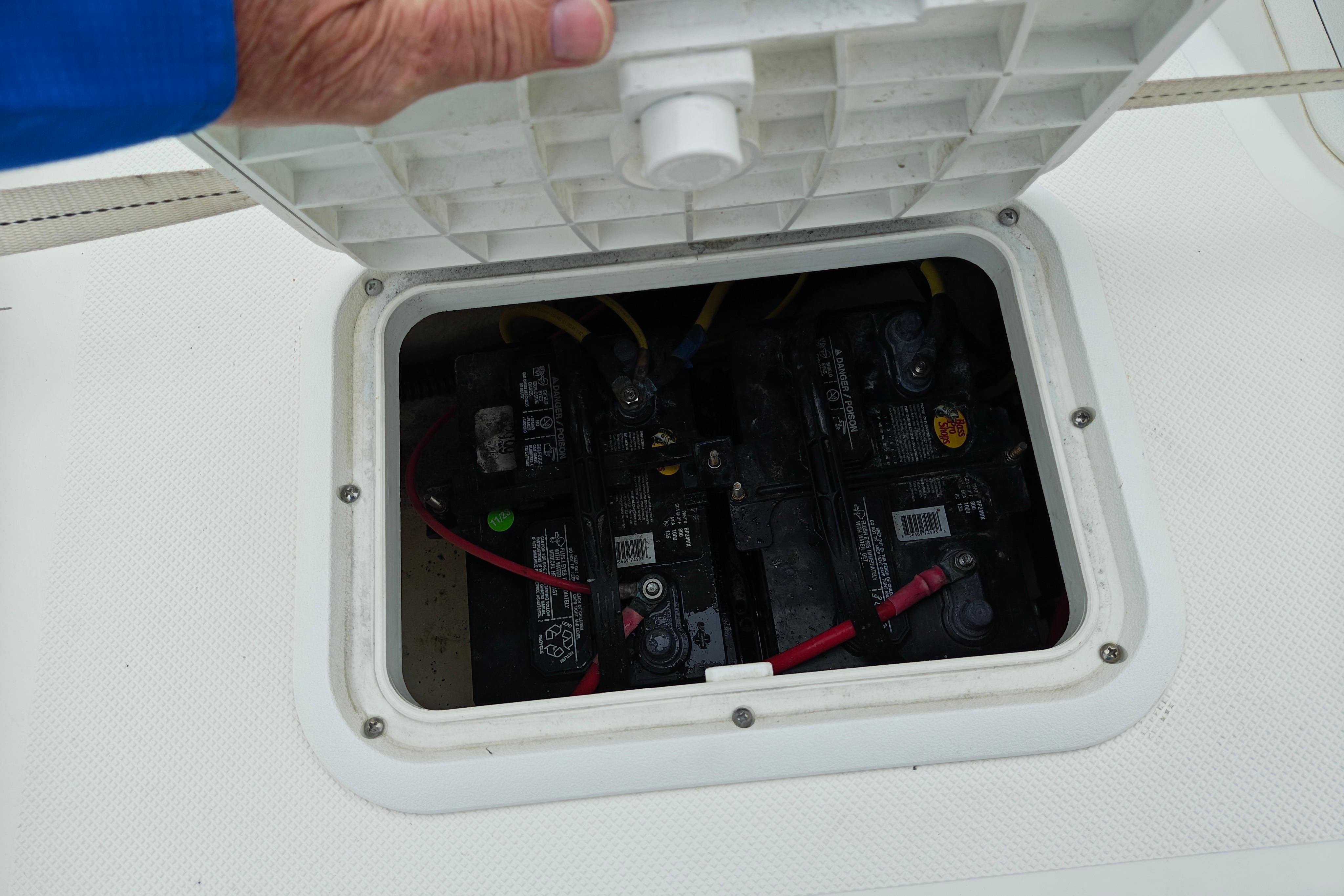 Battery compartment of a 2018 Sundance B20CCR boat, showing multiple connected batteries.