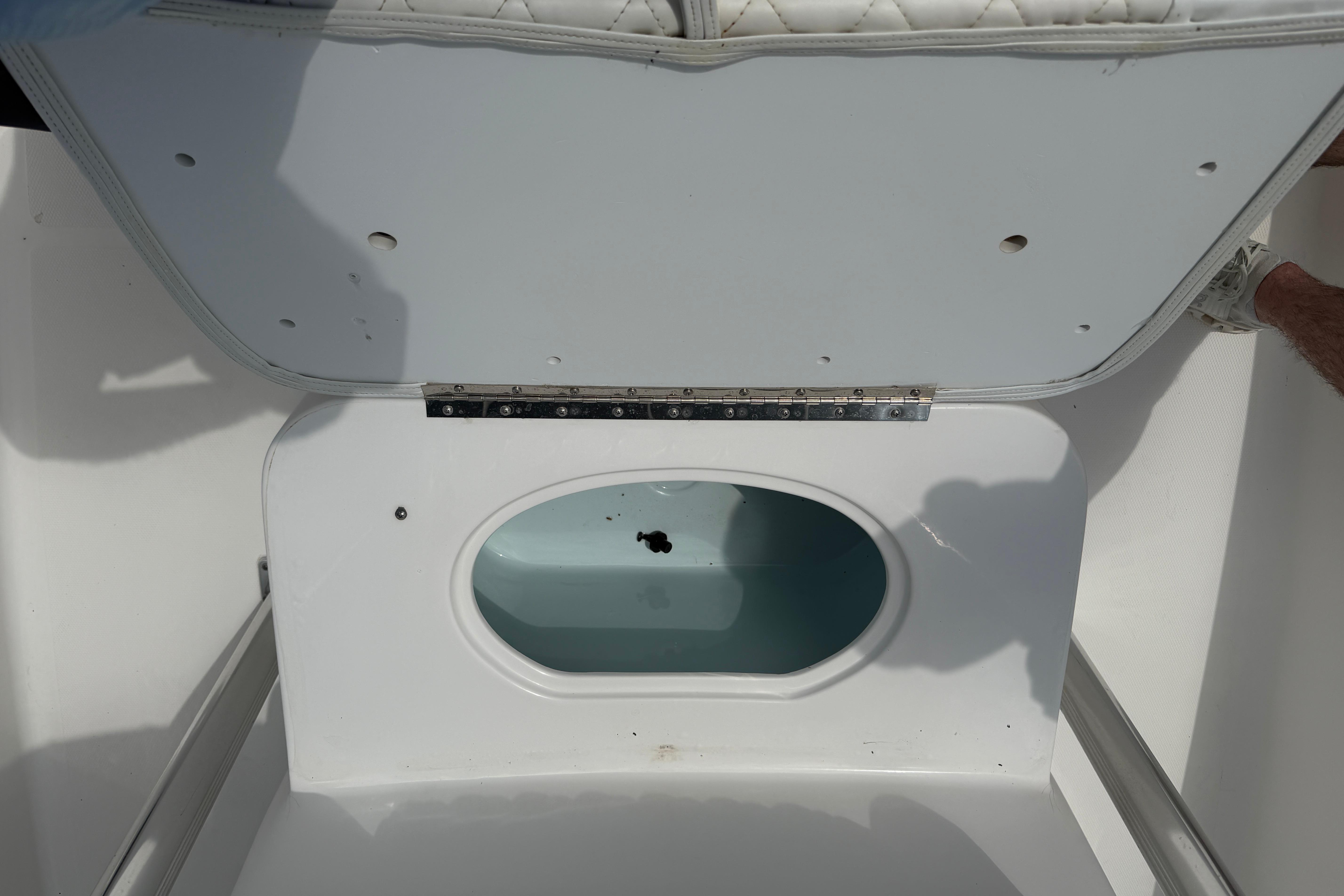 Open storage compartment on a 2015 Sea Hunt Triton 225 boat.