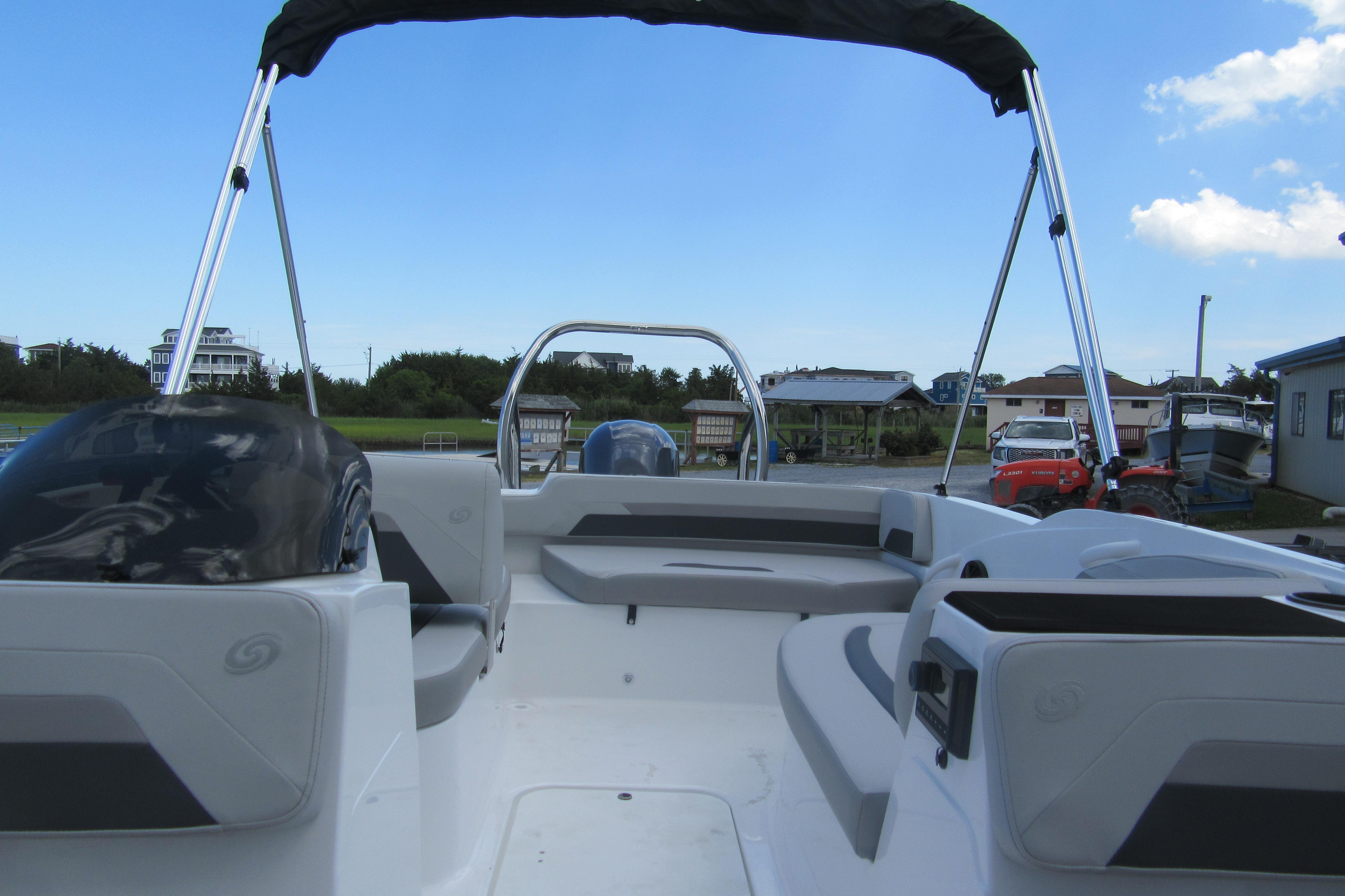 2027 Hurricane SunDeck Sport 185 OB boat interior with seating and canopy.