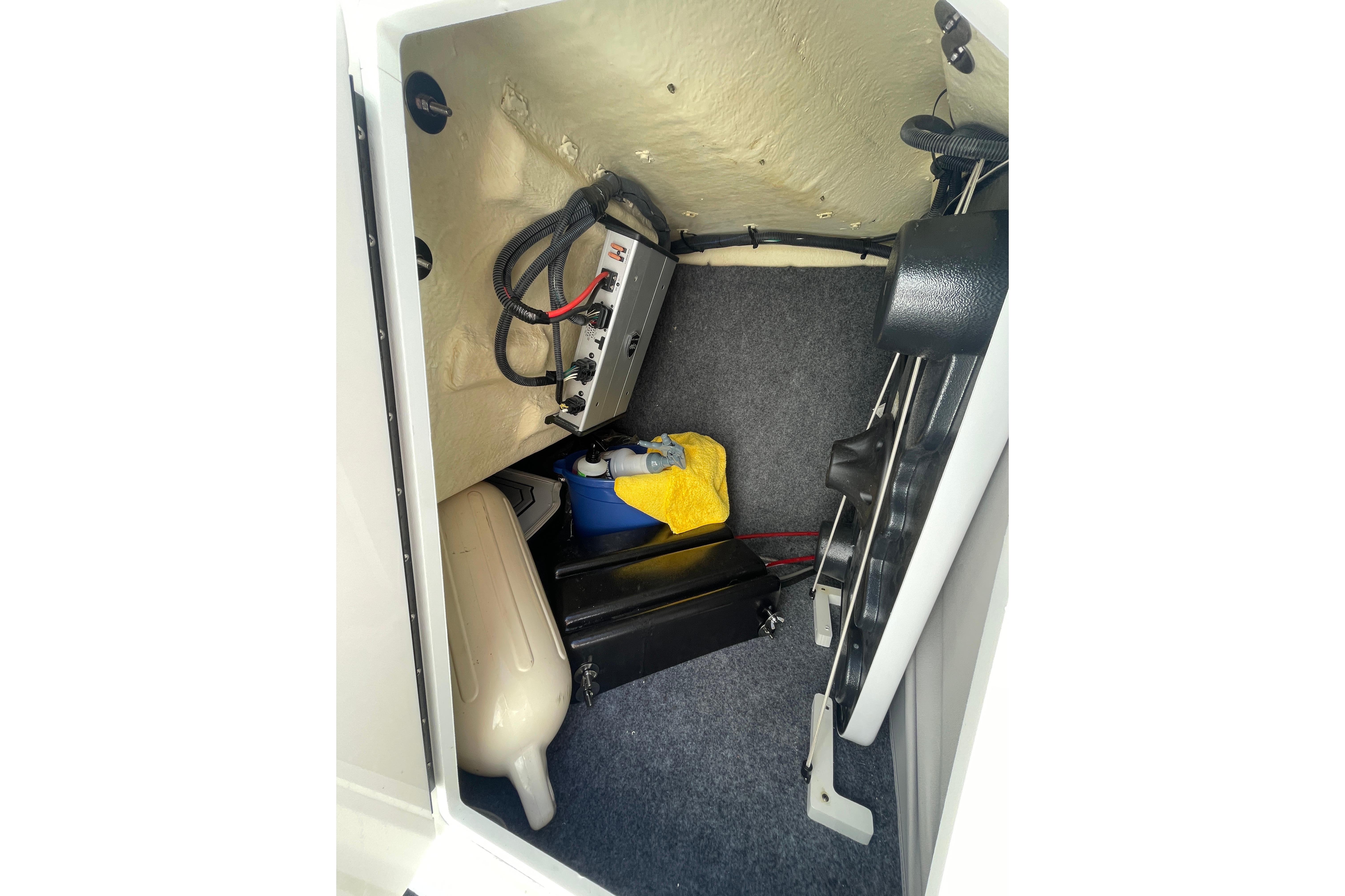 Storage compartment of 2021 Yamaha Boats 275SE with equipment and accessories.