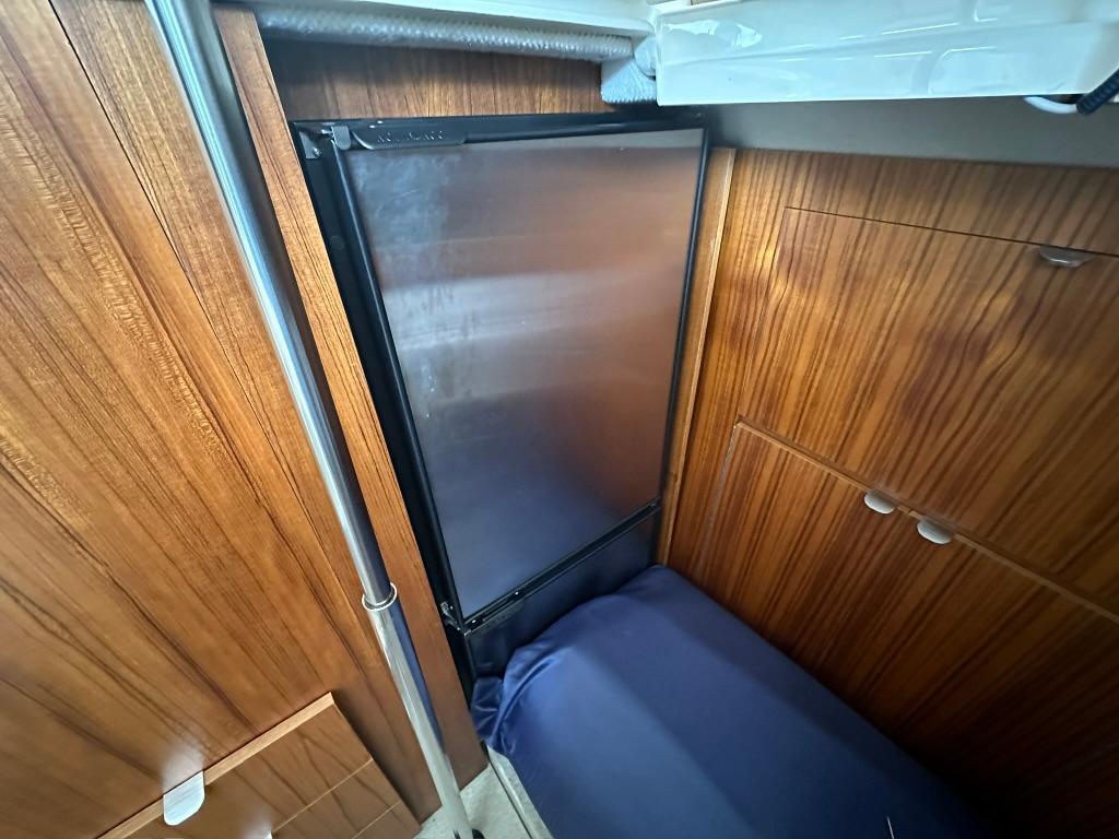 2020 Ranger Tugs R-41 CB interior with wood paneling and compact refrigerator.