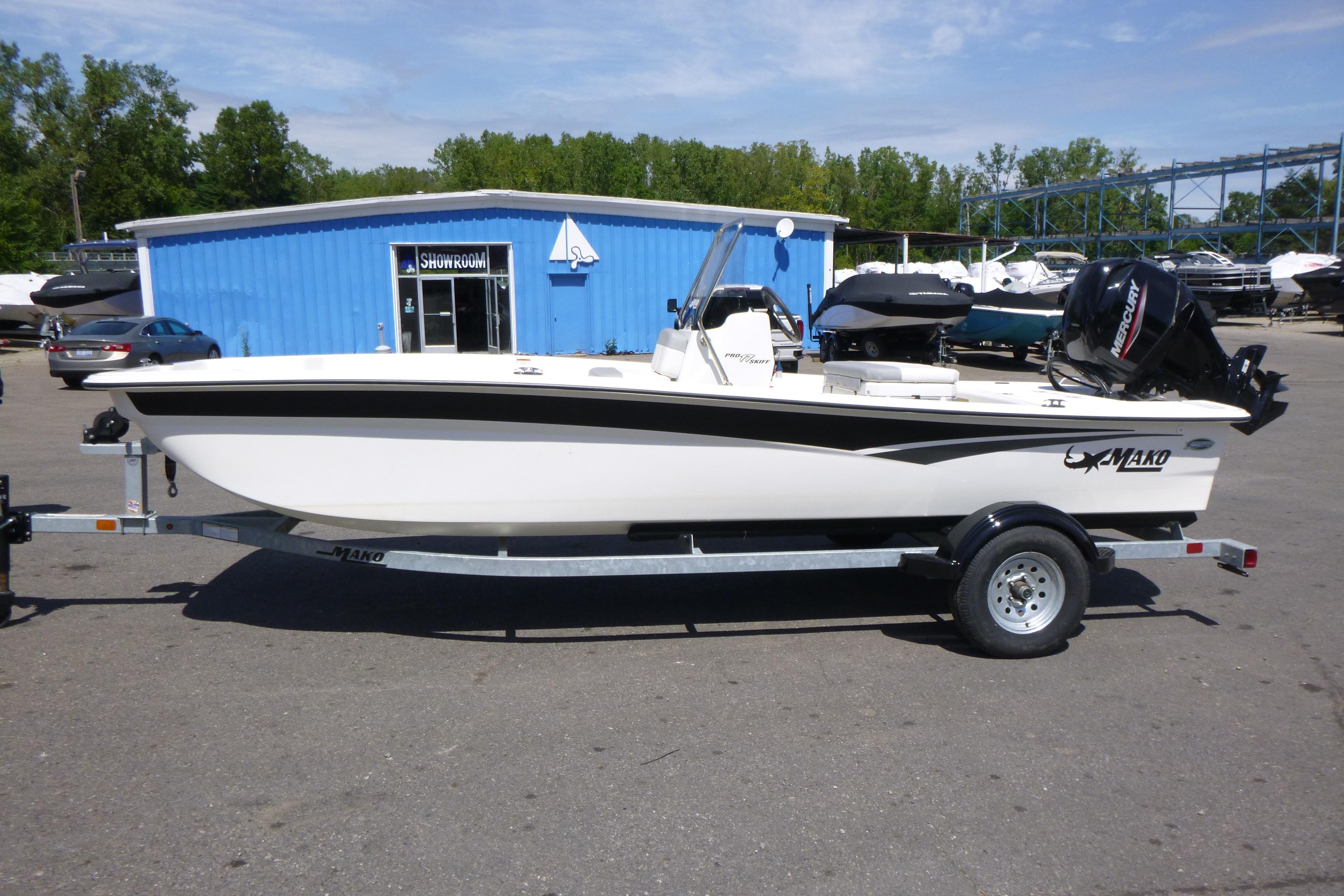 2024 Mako Pro Skiff 17 CC boat on trailer outside showroom.