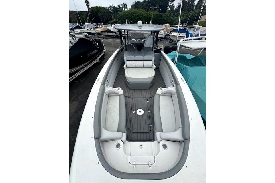 2016 Mystic M4200 boat with spacious seating and sleek design in a marina setting.