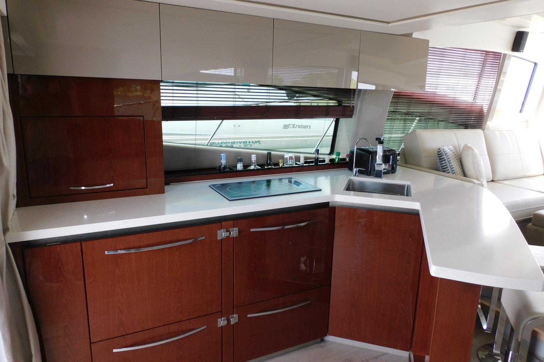 Luxurious 2019 Sea Ray L550 yacht kitchen with modern cabinetry and sleek countertops.