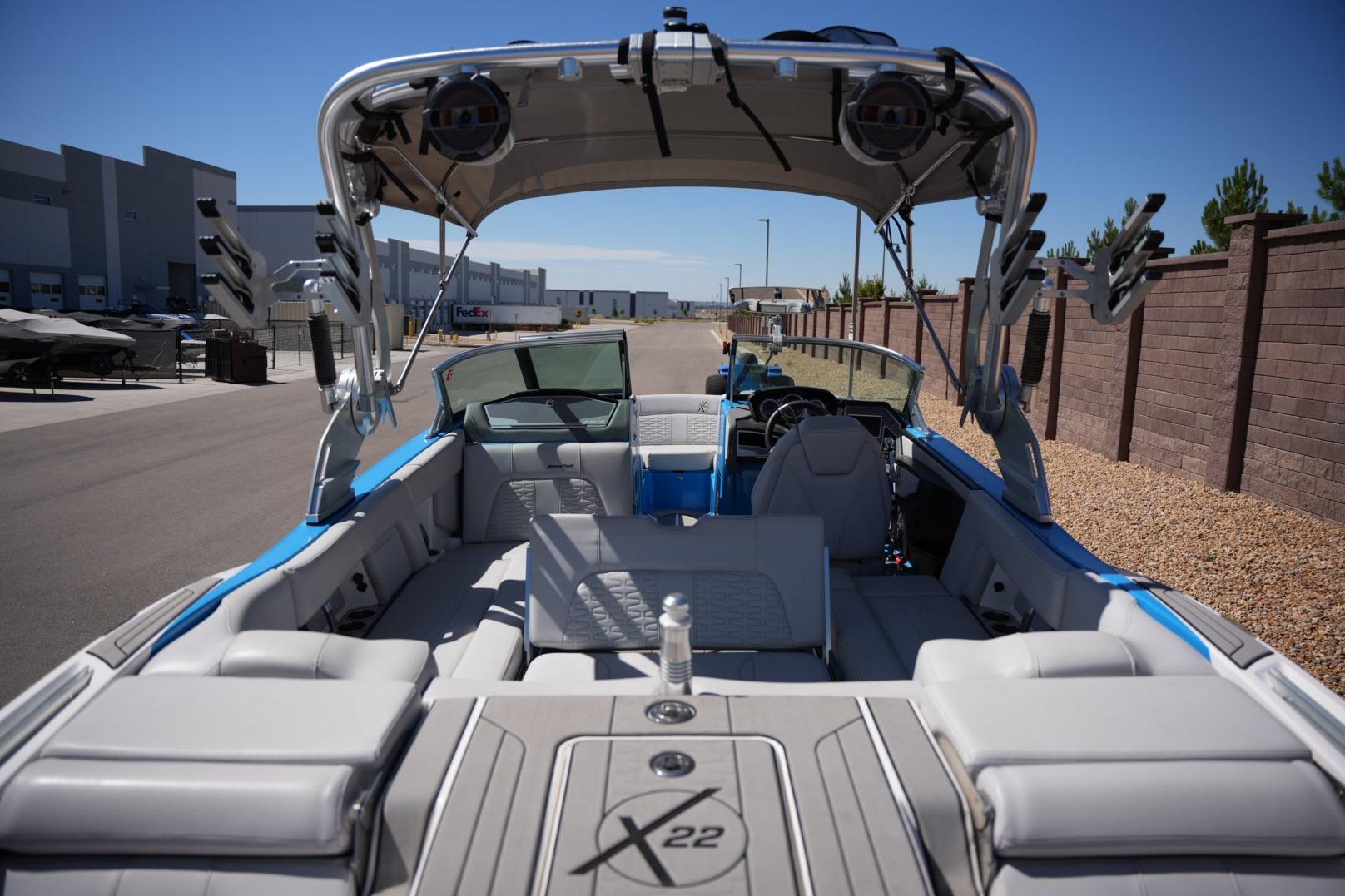 2020 MasterCraft X22 boat interior with seating and wakeboard racks, parked outdoors.