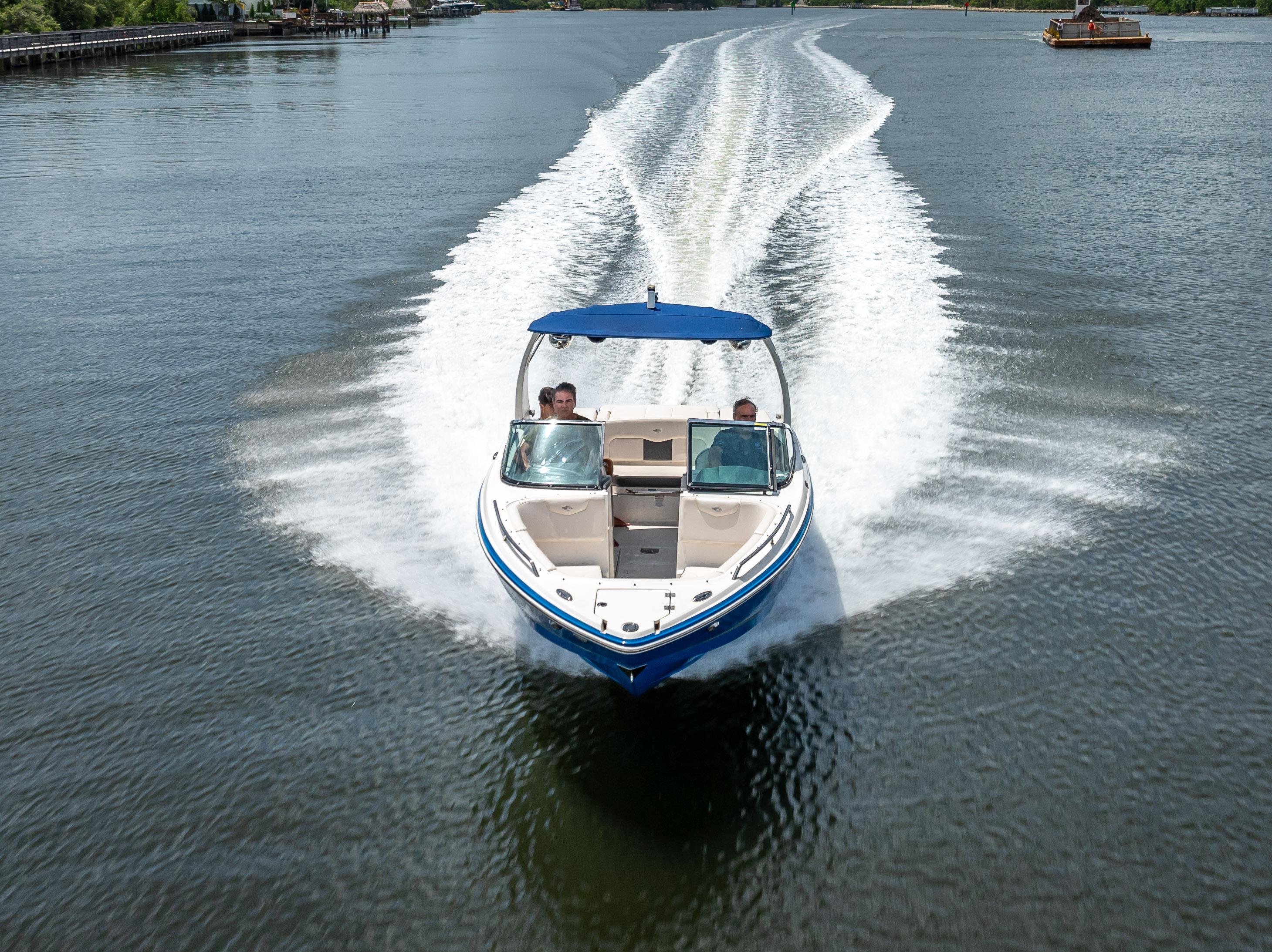 2017 Chaparral 227 SSX speedboat cruising on a calm lake.
