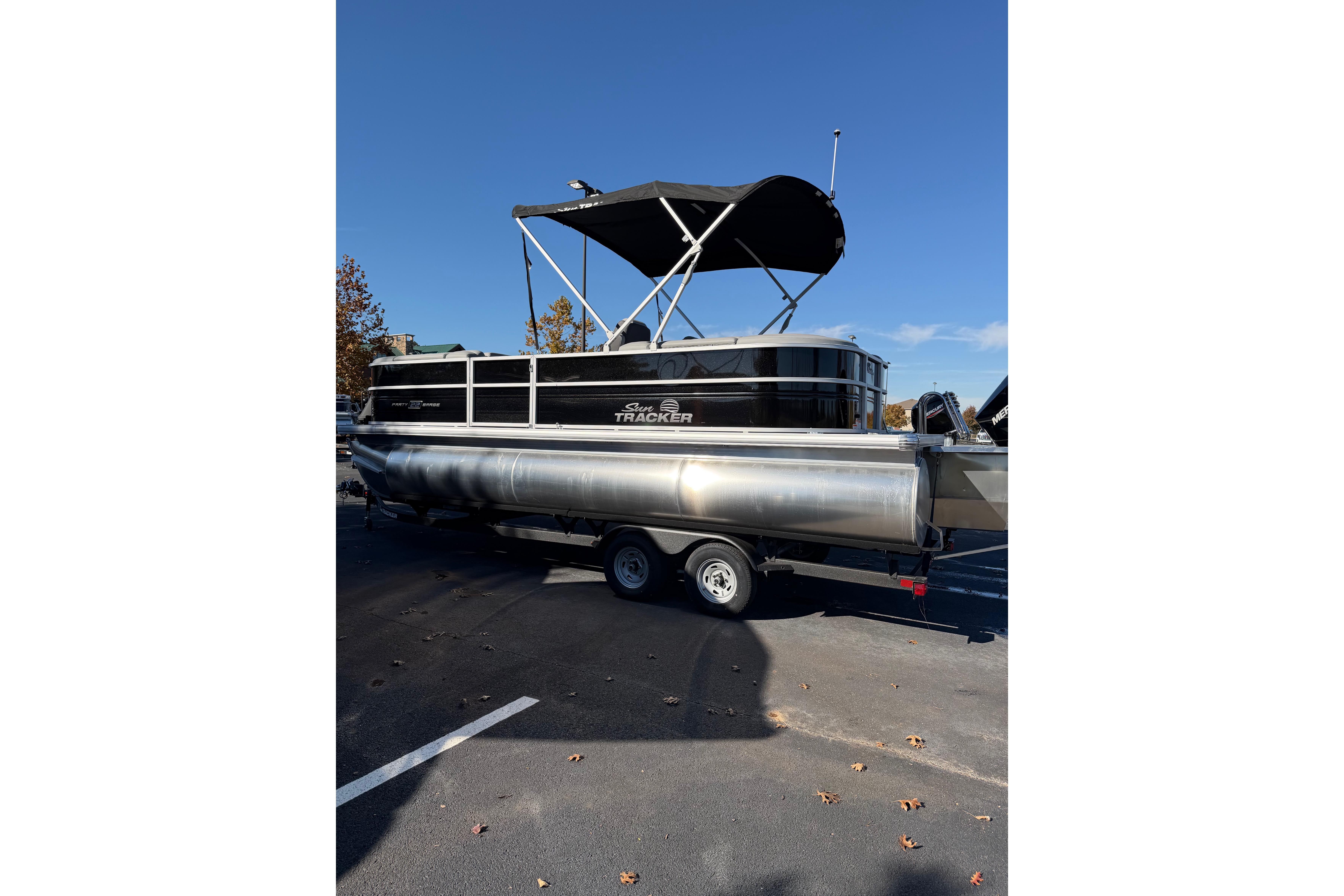 2026 Sun Tracker Party Barge 22 XP3 pontoon boat with canopy on trailer.