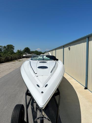 2005 Cobalt 343 boat on trailer, parked near a building.