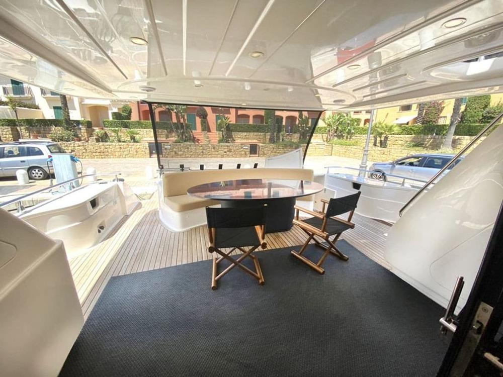 Astondoa 82 GLX 2000 yacht deck with seating area and table, featuring modern design.
