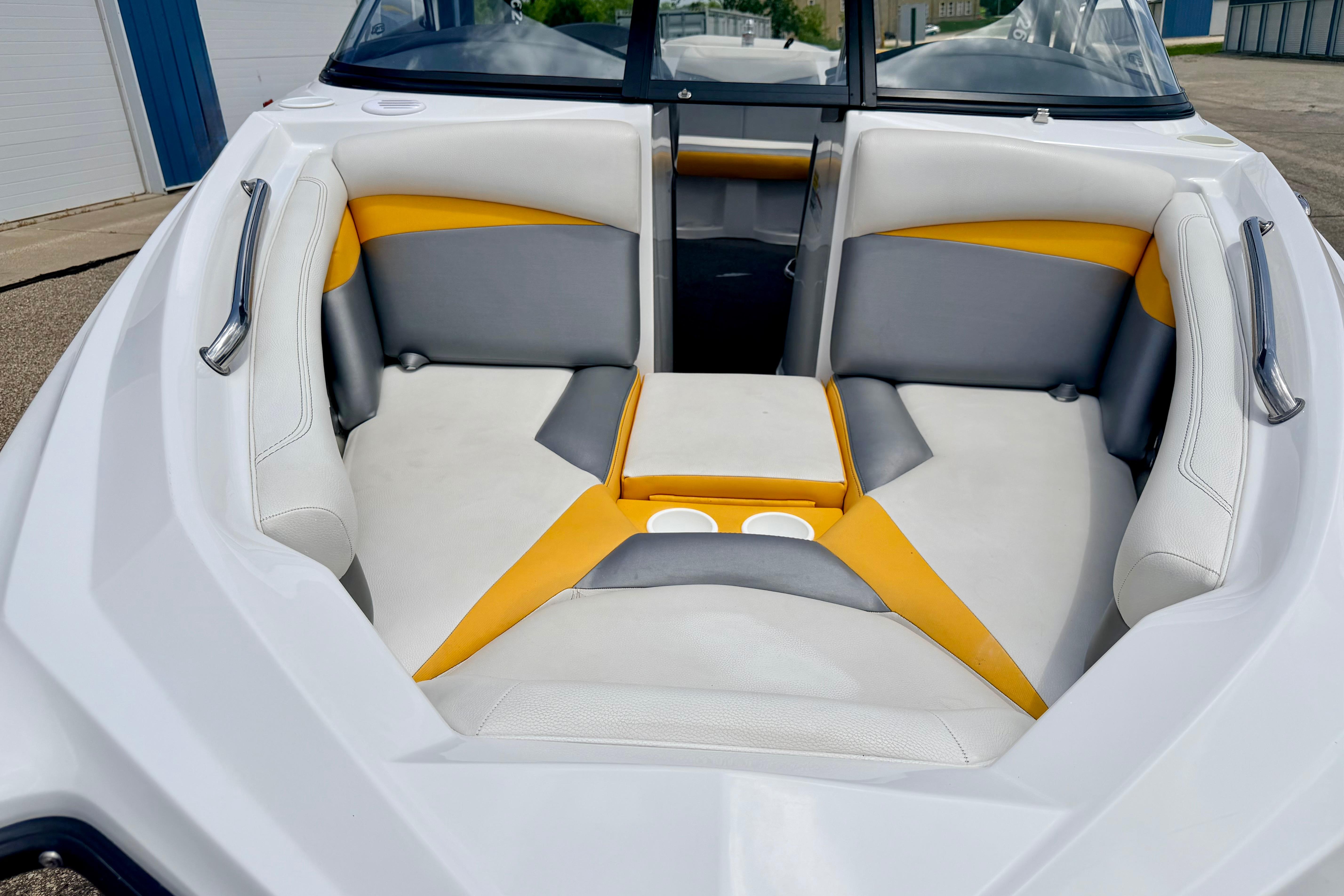 2014 Tigé R20 boat interior with white, gray, and yellow seating, featuring cup holders.