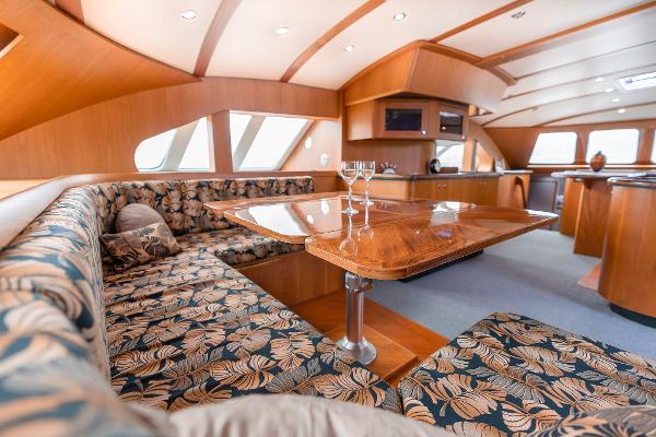 Luxurious interior of 2025 Shuttleworth 52 AeroRig yacht with elegant wood and floral upholstery.