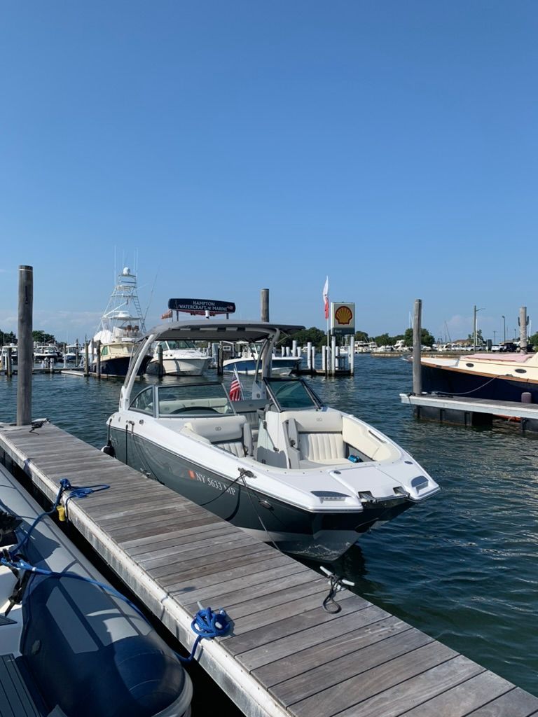 2020 Cobalt SC23 boat docked on a sunny day.
