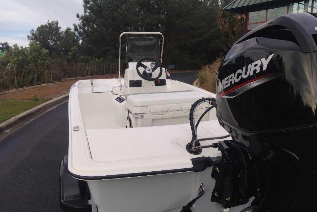 2026 Mako Pro Skiff 15 CC boat with Mercury engine, parked outdoors.