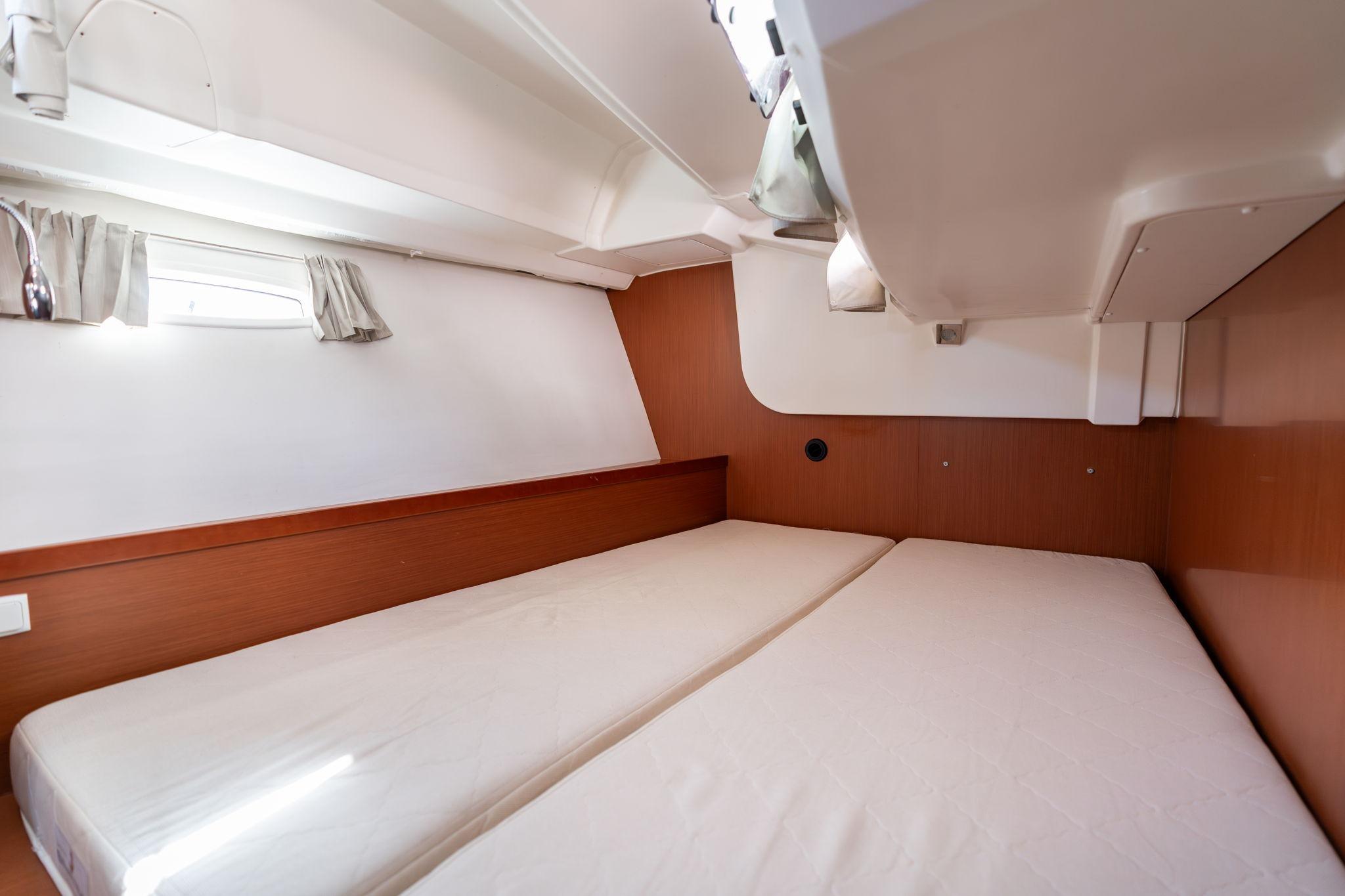 2013 Beneteau Oceanis 50 cabin interior with twin beds and wooden paneling.