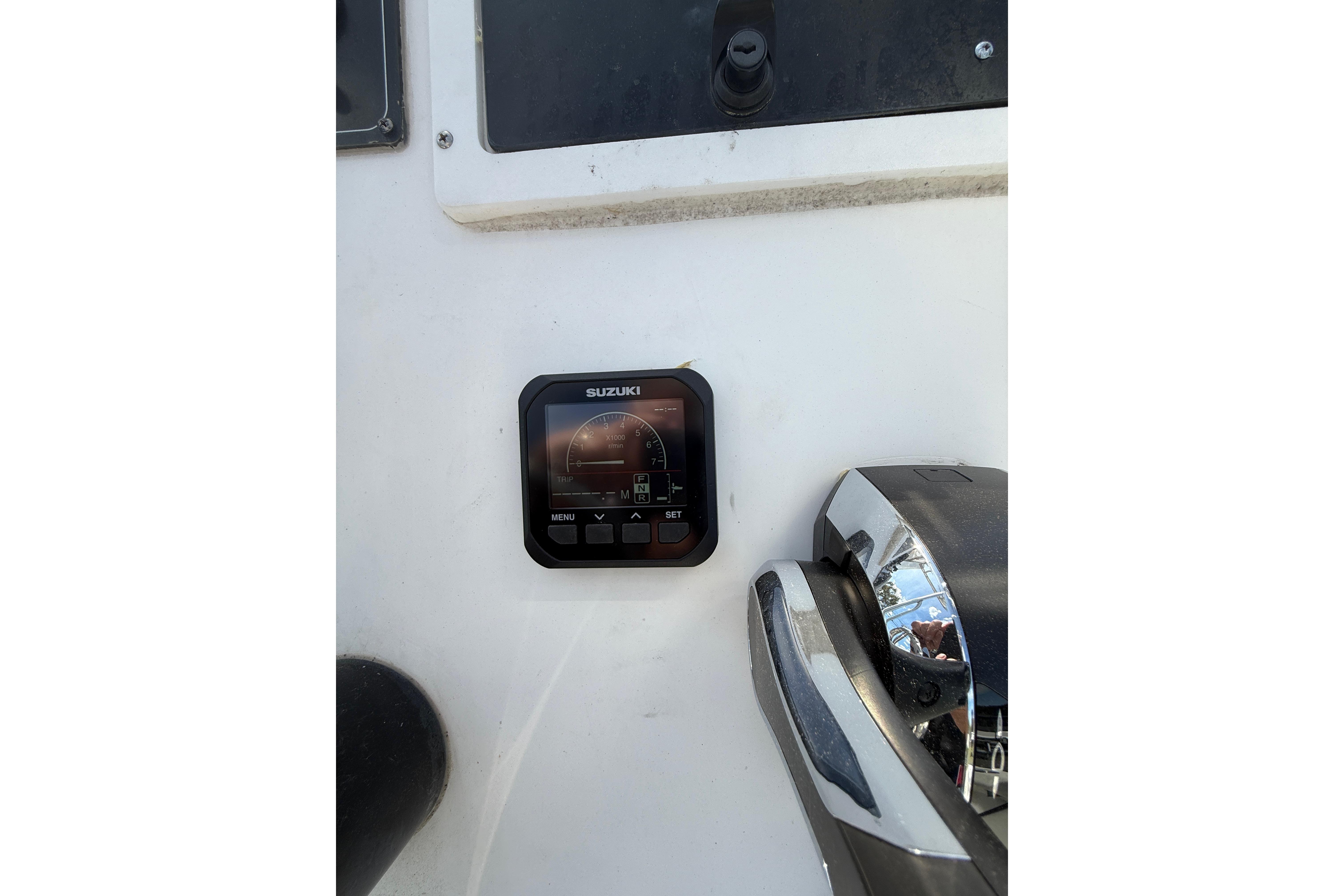 Suzuki display and controls on 2008 Key Largo 206 Center Console boat dashboard.