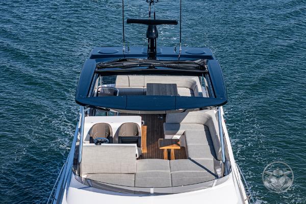 Sunseeker Manhattan 68 yacht 2025, top view, luxurious seating, open sea background.