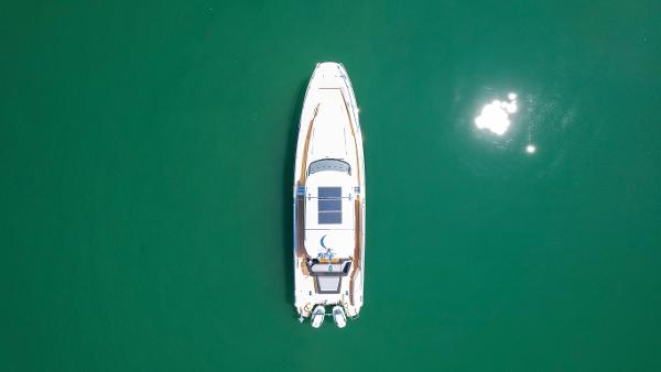Aerial view of 2025 Nimbus T11 boat on calm green water.