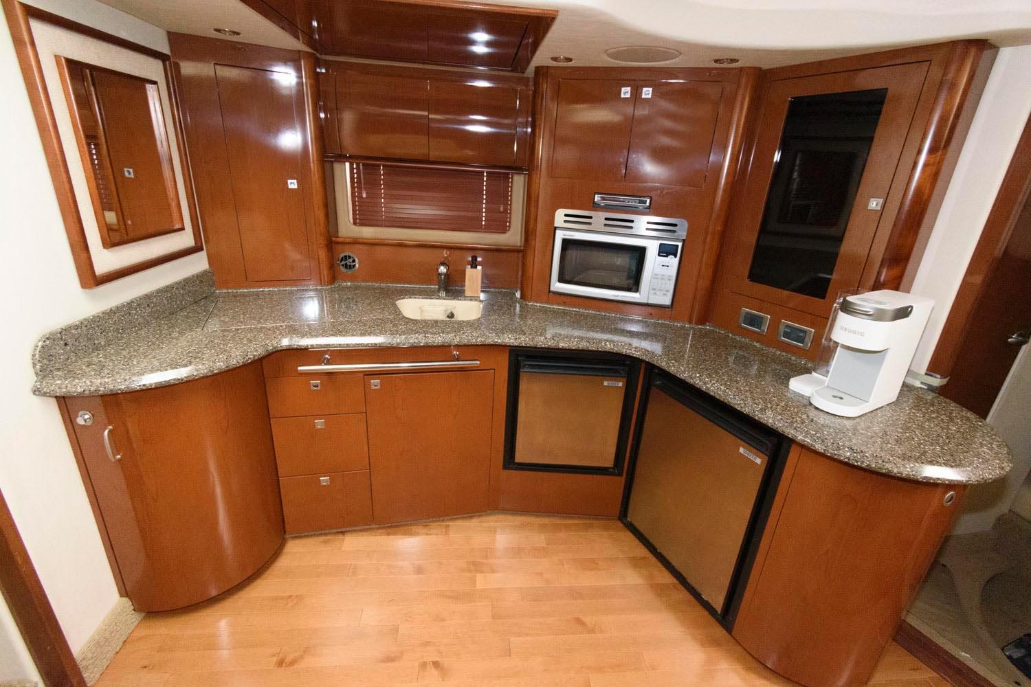 Luxurious kitchen interior of 2008 Sea Ray 44 Sundancer yacht with modern appliances.