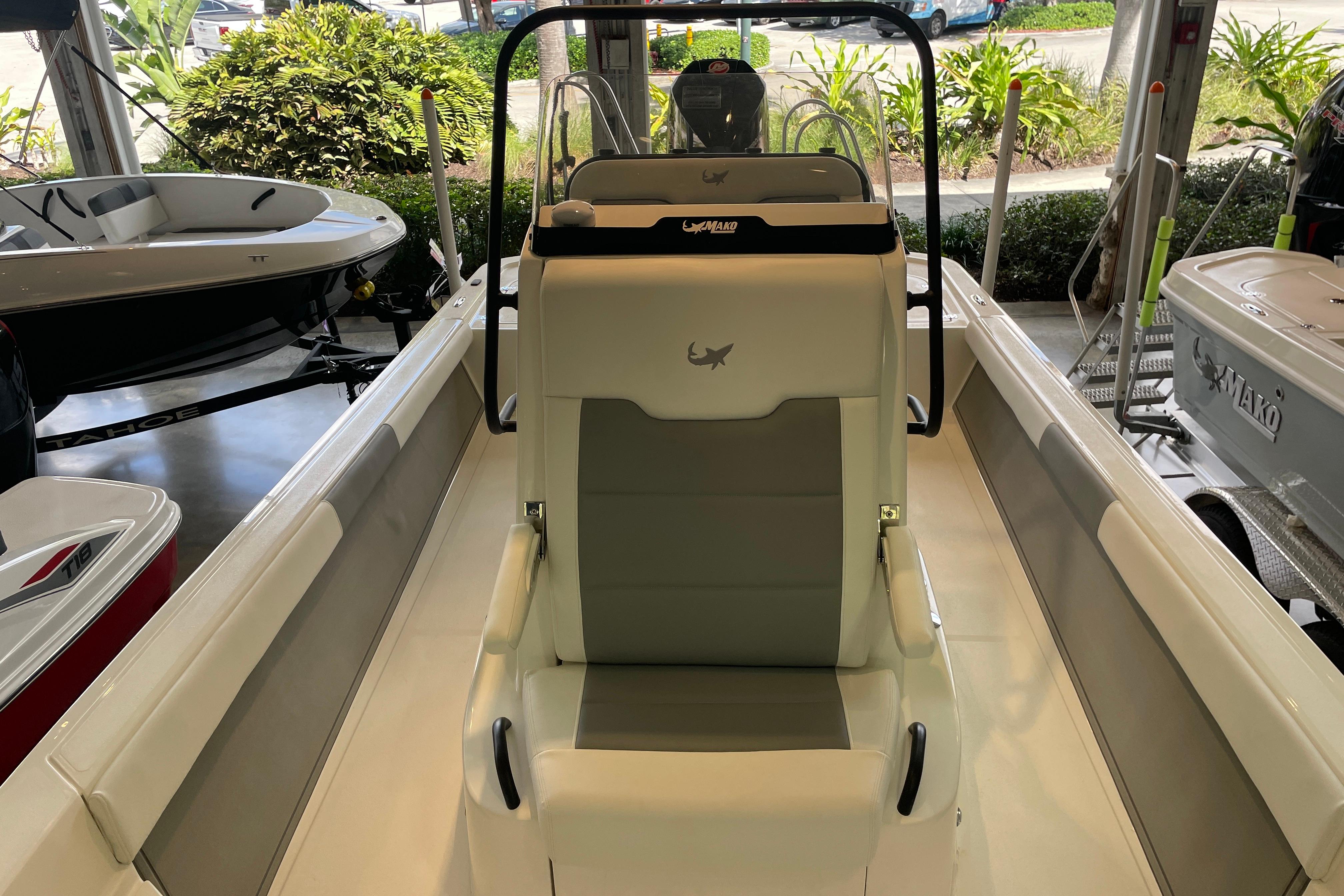 2026 Mako 24 APEX boat interior with sleek seating and modern design in showroom.