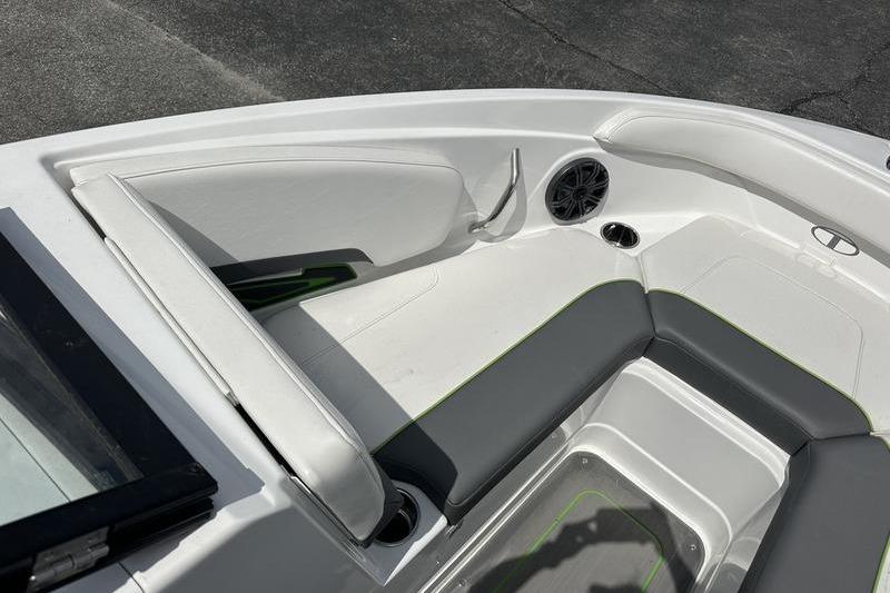 2024 Tahoe 210 S boat interior with white and gray seating, cup holder, and speaker.