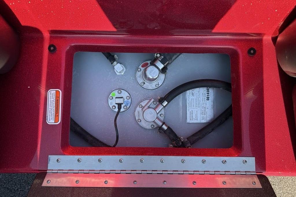 Fuel compartment of a 2026 Nitro Z17 boat, featuring hoses and warning label.