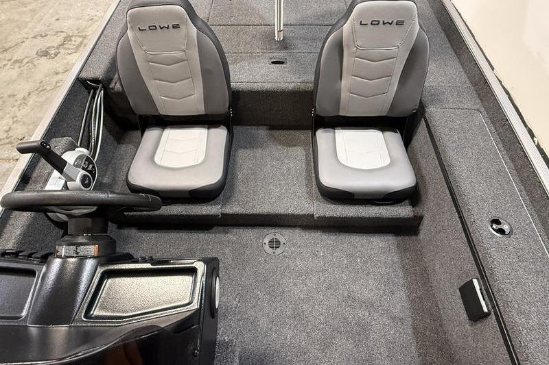 2026 Lowe Skorpion 16 boat interior with dual gray seats and steering console.