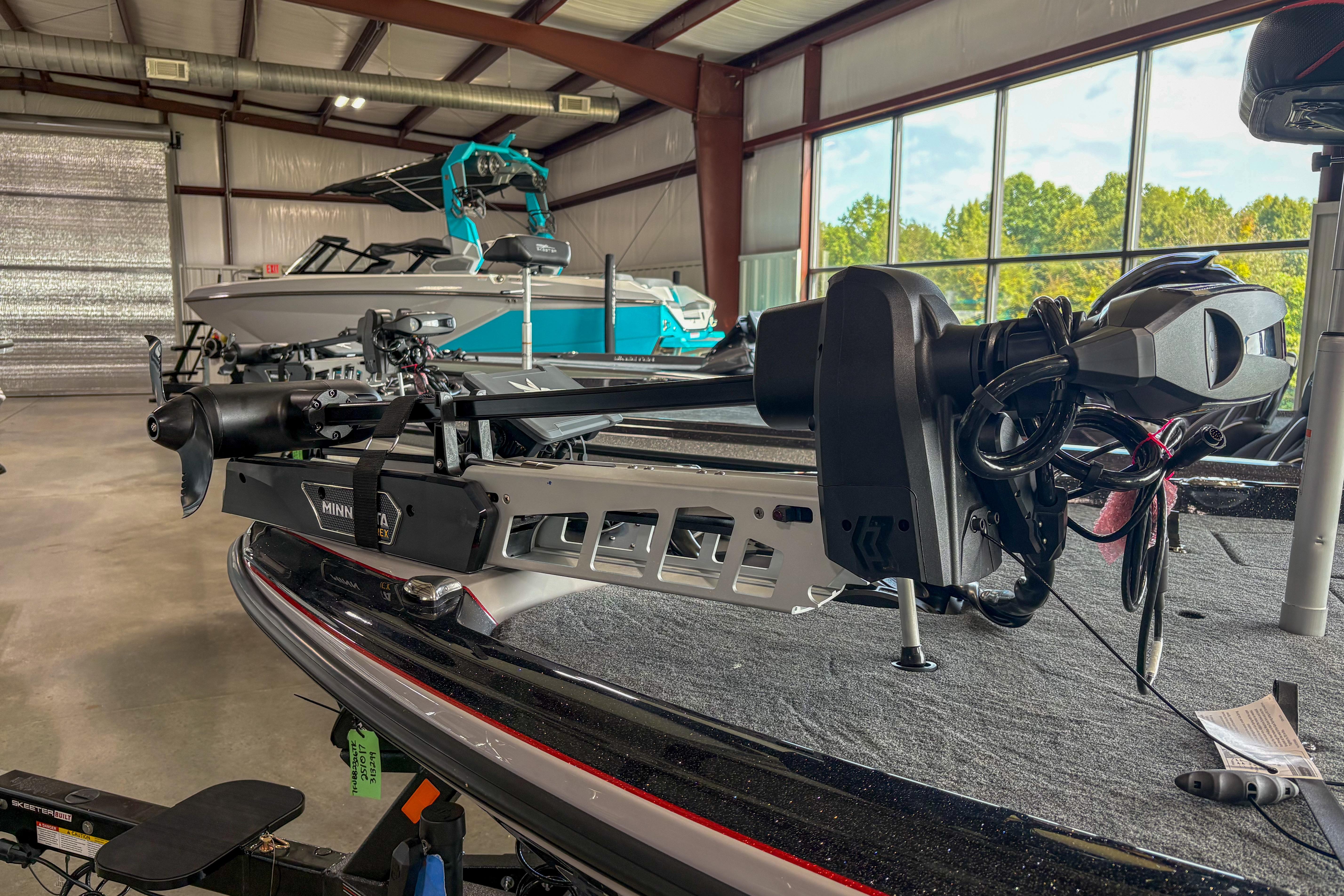 2026 Skeeter ZXE20 boat with Minn Kota trolling motor in a showroom.