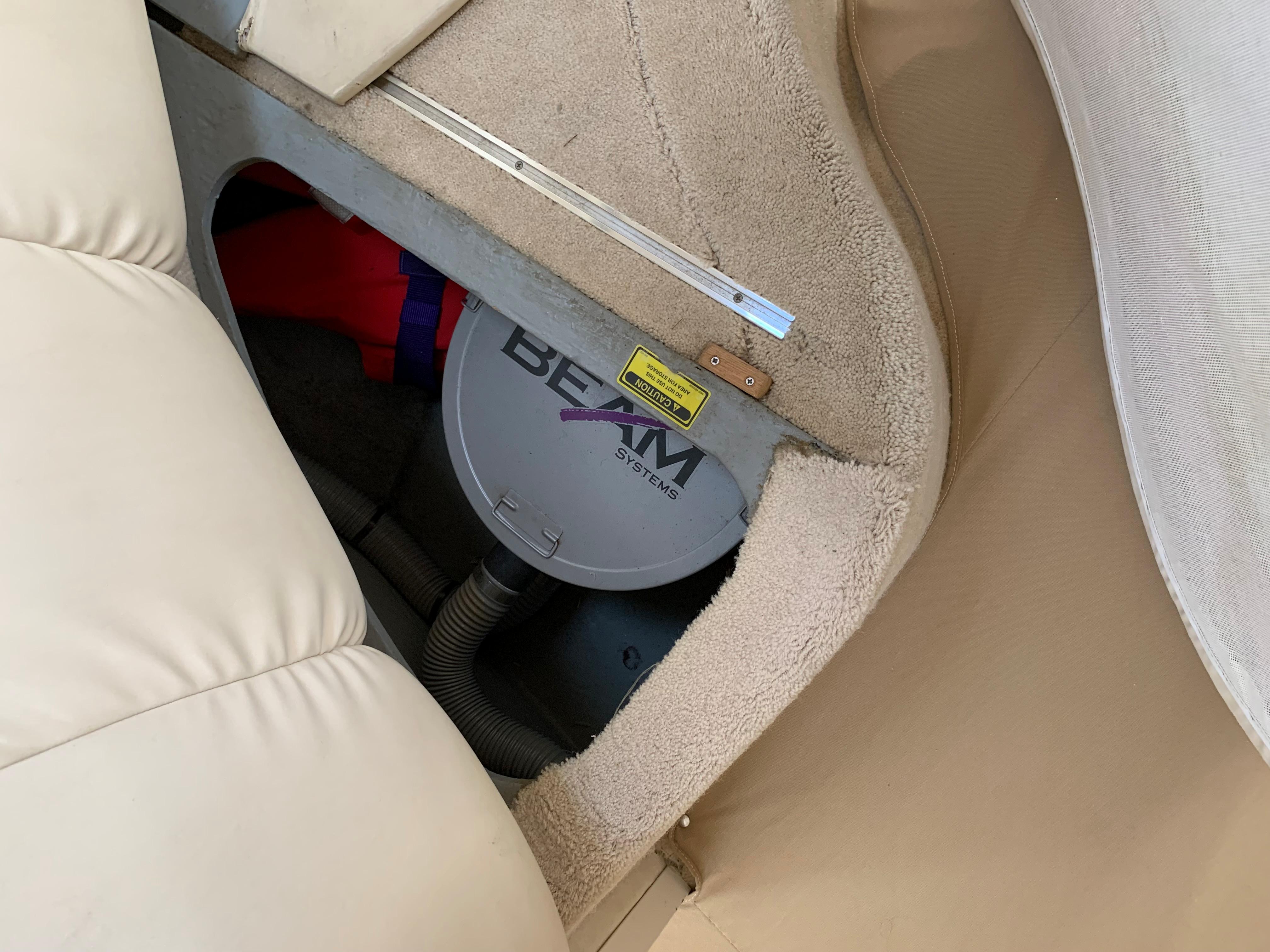 1997 Sea Ray 400 Sundancer interior showing a BEAM central vacuum system under seating.