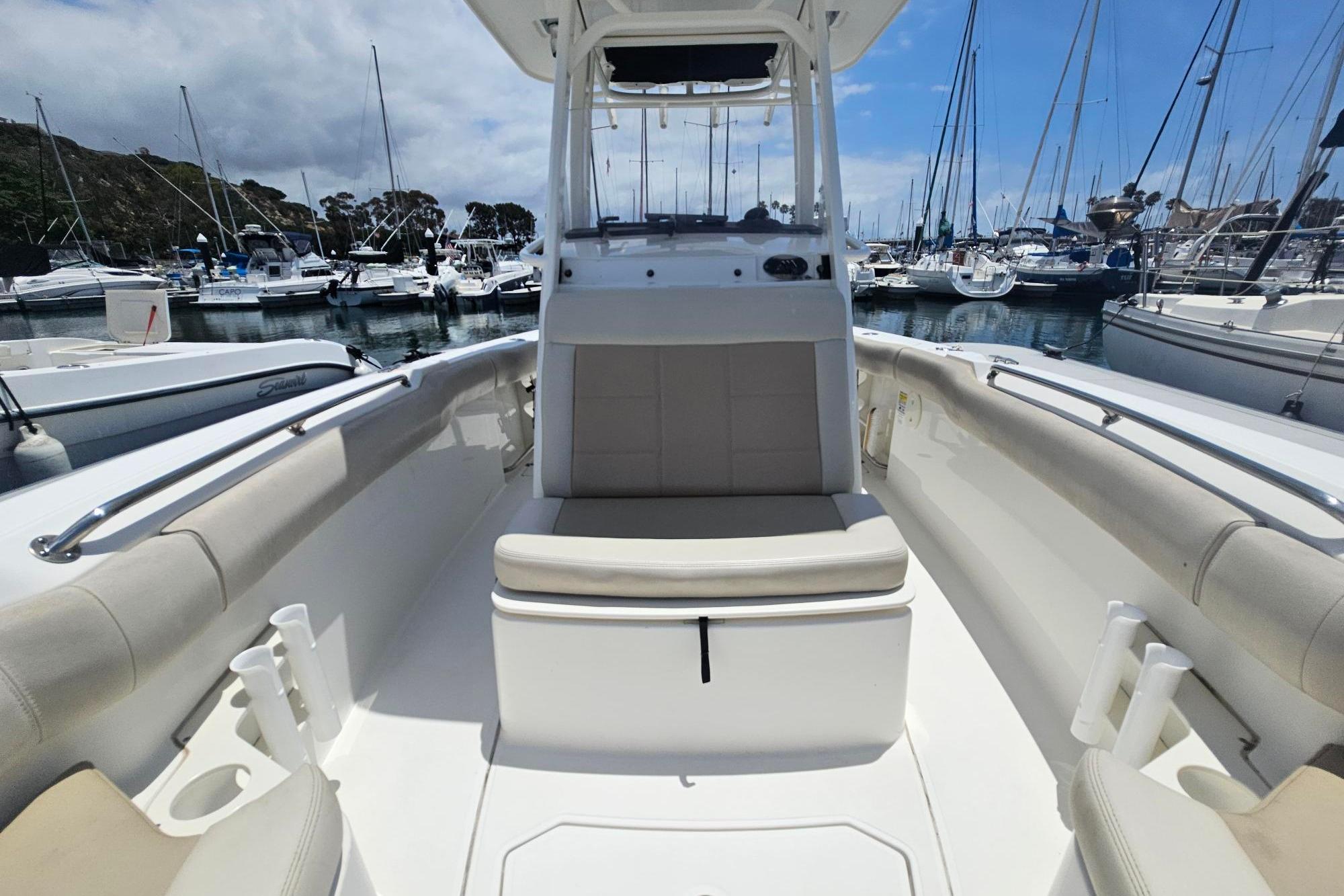 2017 Boston Whaler 230 Outrage boat interior at marina, showcasing seating and console.