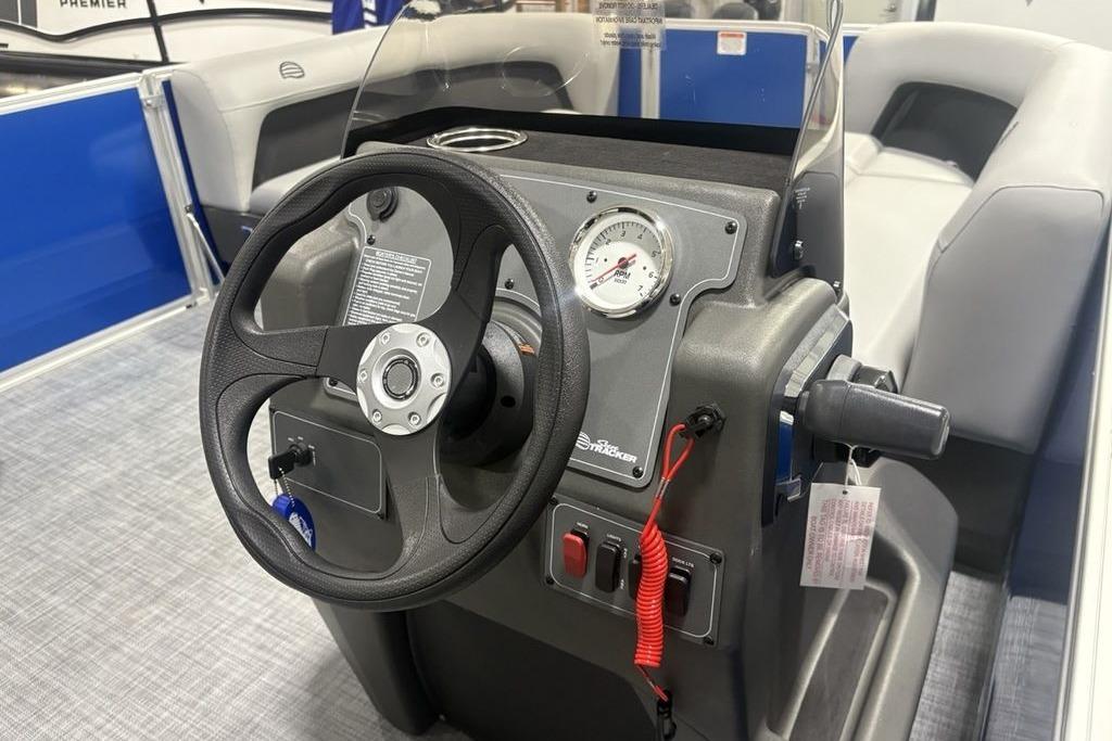 2026 Sun Tracker Party Barge 16 DLX steering console with gauge and controls.