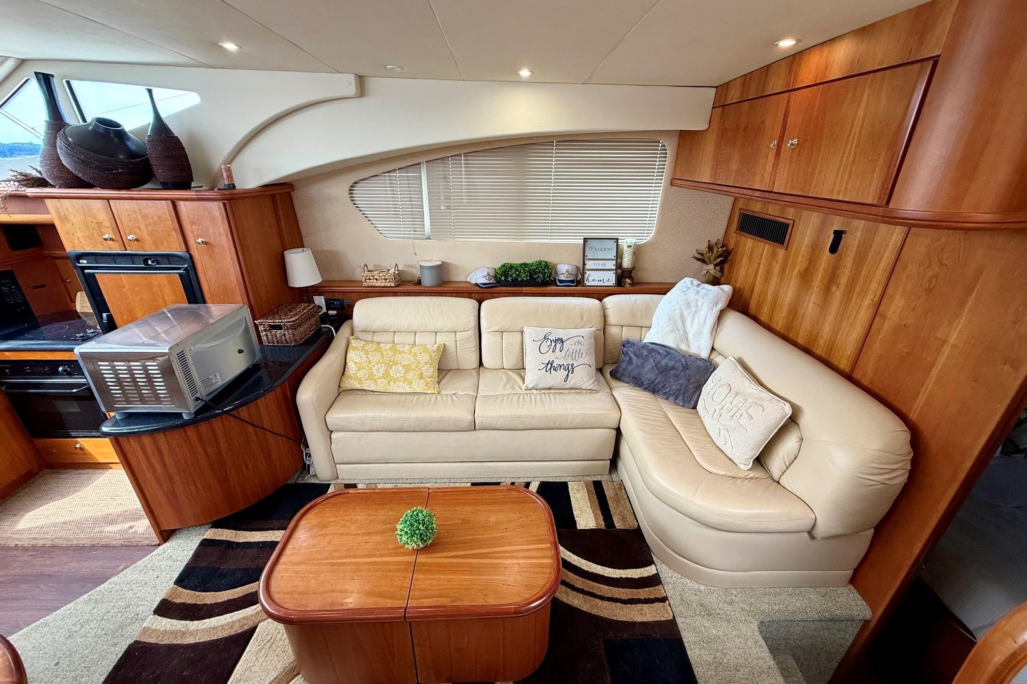 Luxurious interior of 2004 Silverton 39 Motor Yacht with plush seating and elegant decor.