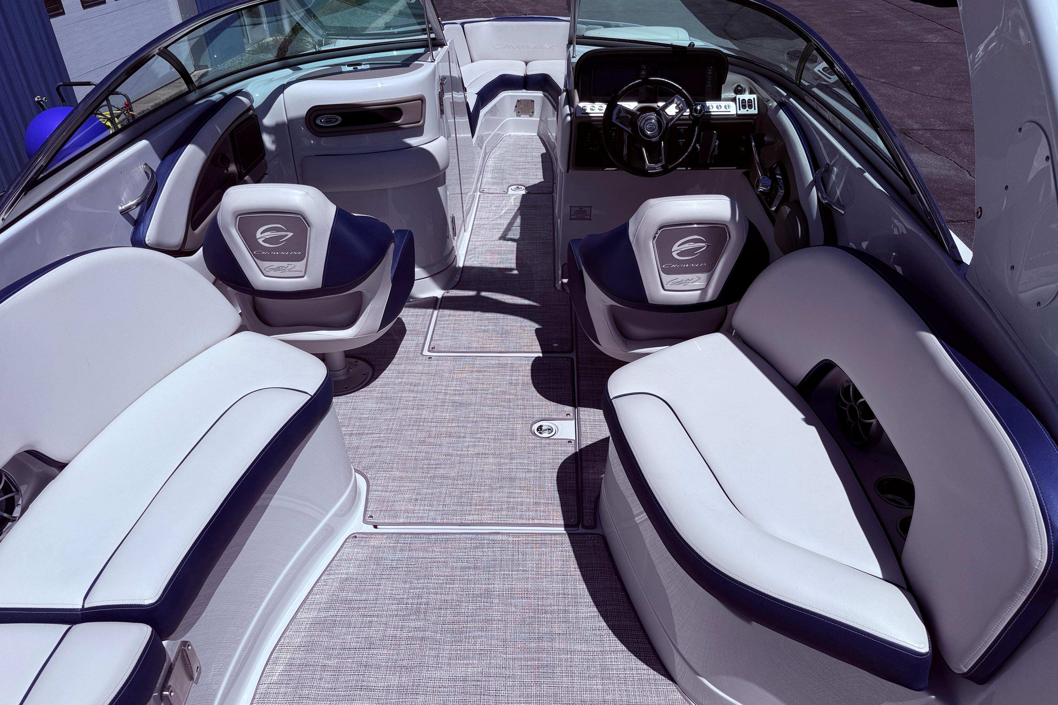 Interior of 2025 Crownline 290 XSS boat with luxurious seating and modern dashboard.