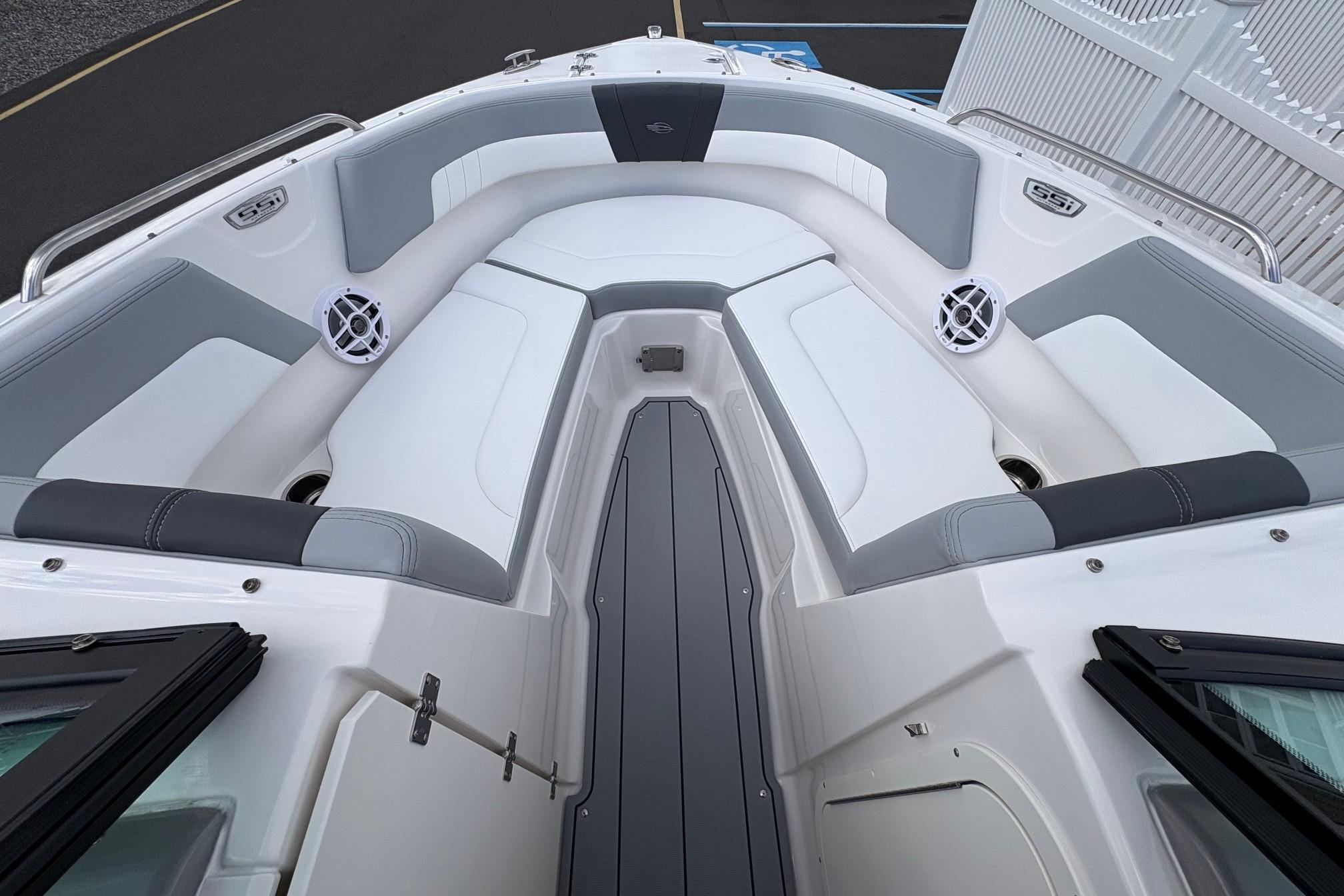 2026 Chaparral 23 SSi OB boat interior with gray and white seating, speakers, and sleek design.
