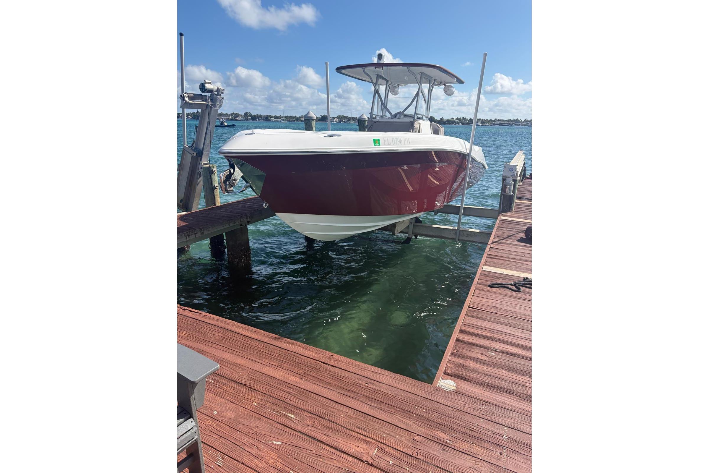 2015 Deep Impact 33 boat docked on a sunny day, showcasing sleek design and vibrant colors.