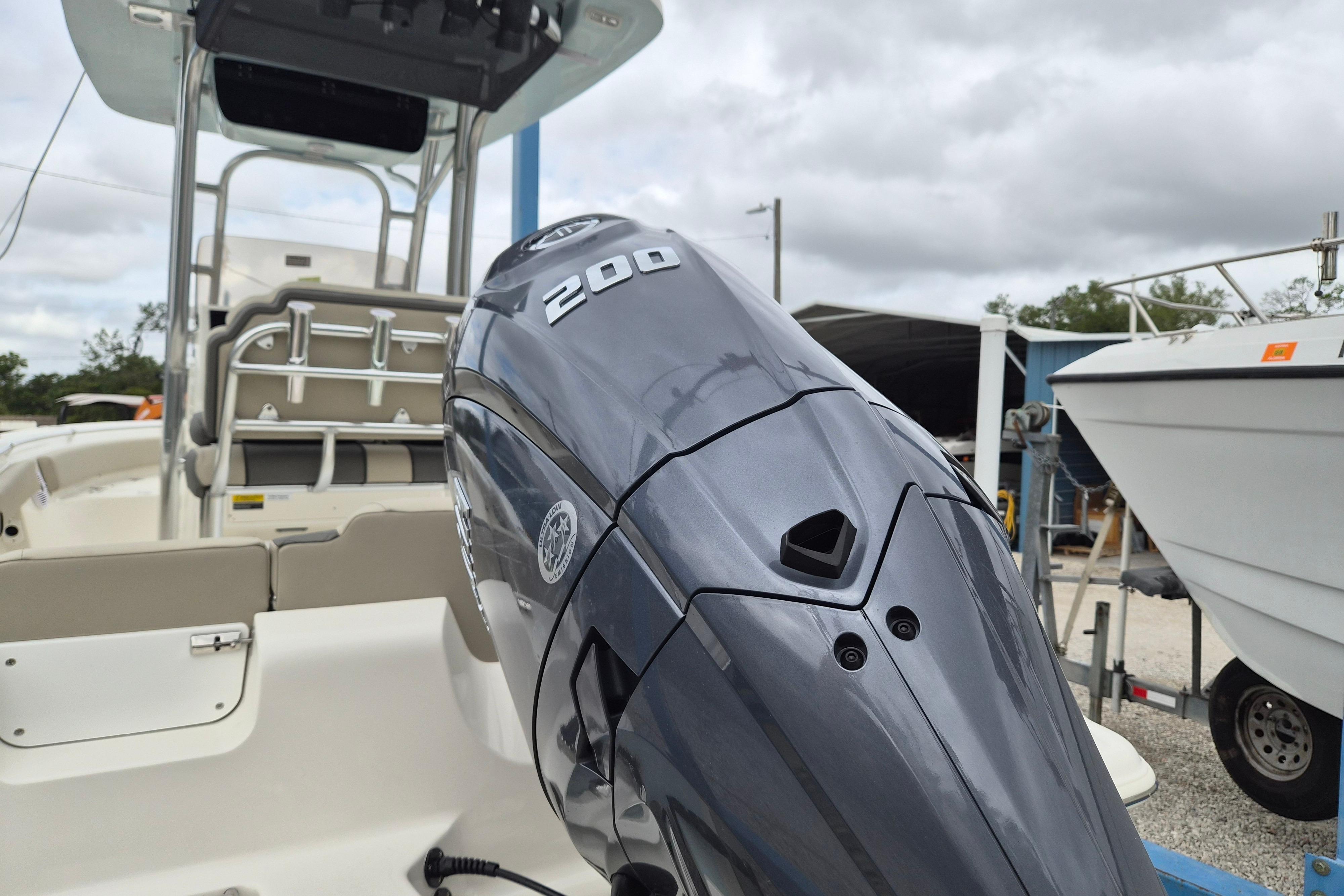 2026 Key West 219 FS boat with powerful 200 HP engine, docked outdoors.