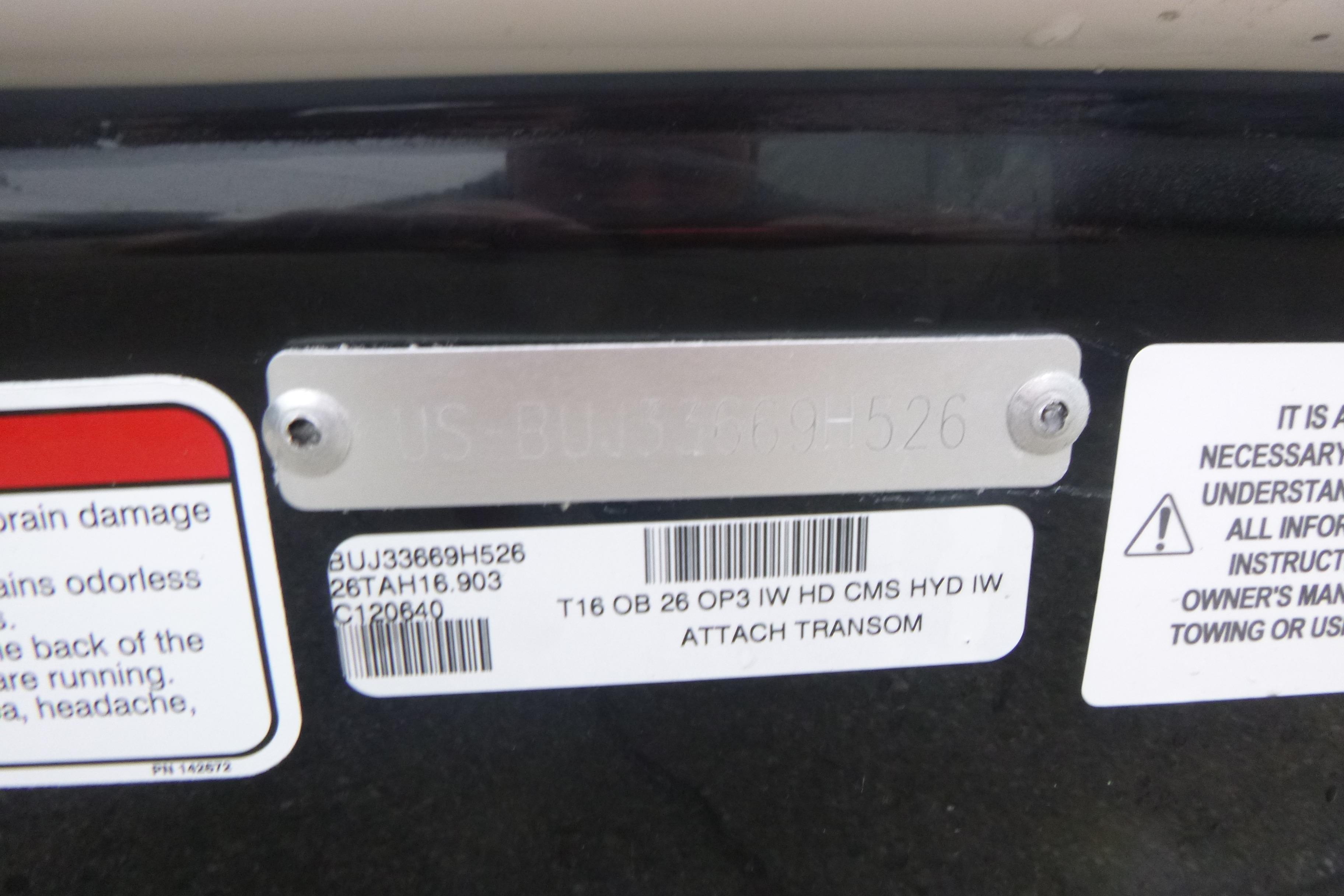 Serial number plate on a 2026 Tahoe T16 boat with warning labels.